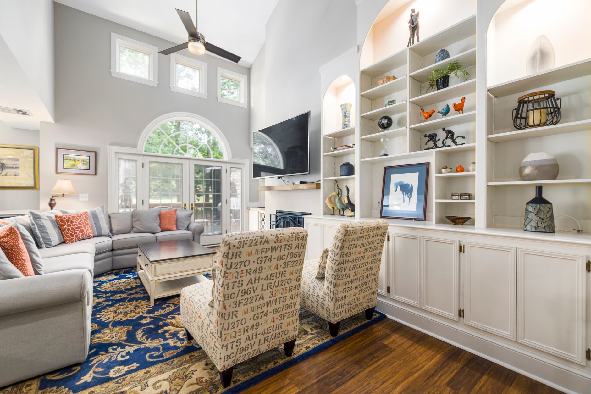 Elegant living room featuring modern furniture, vibrant colors, and abundant natural light.