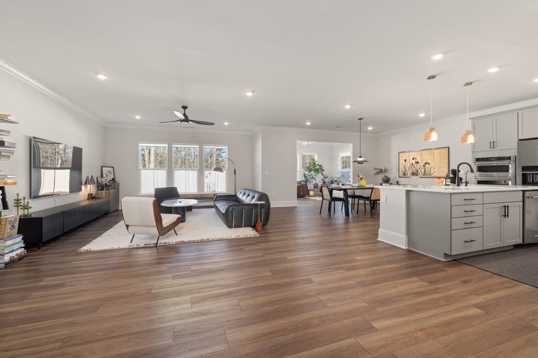Bright and airy open-concept living space with kitchen, featuring modern furniture and elegant decor.