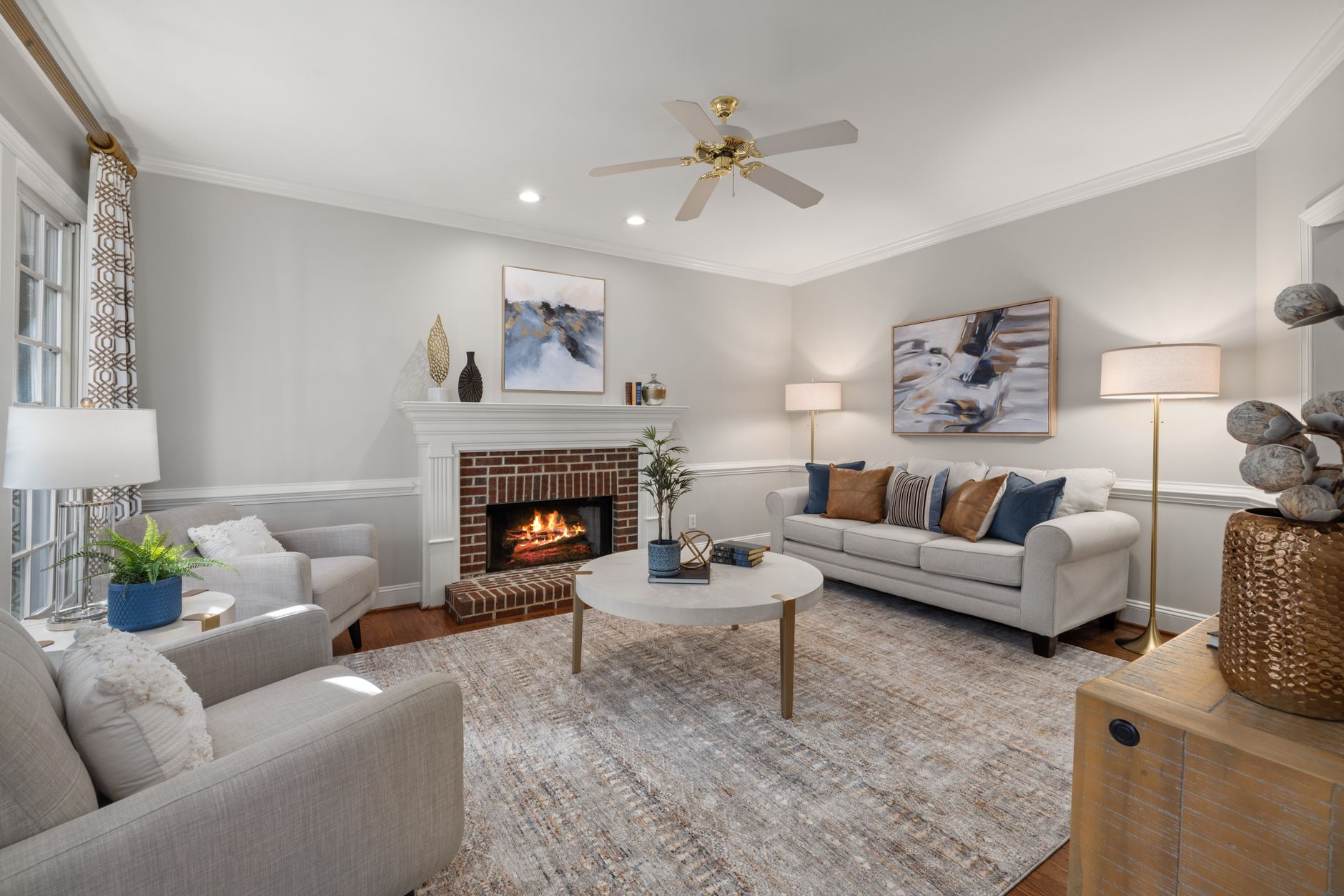 A cozy modern living room featuring a fireplace, elegant sofa, and tasteful decor.