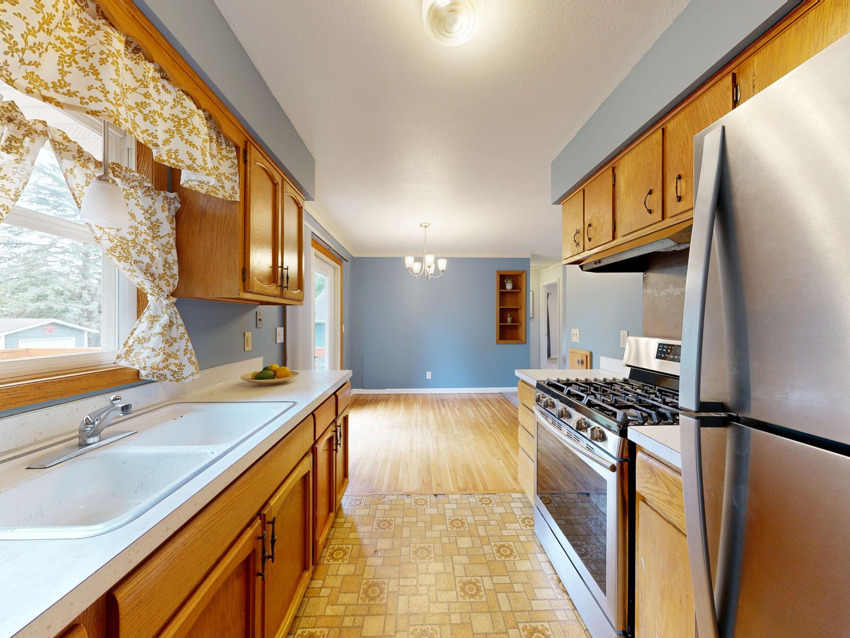 Bright kitchen featuring wooden cabinets, modern stove, and natural light.