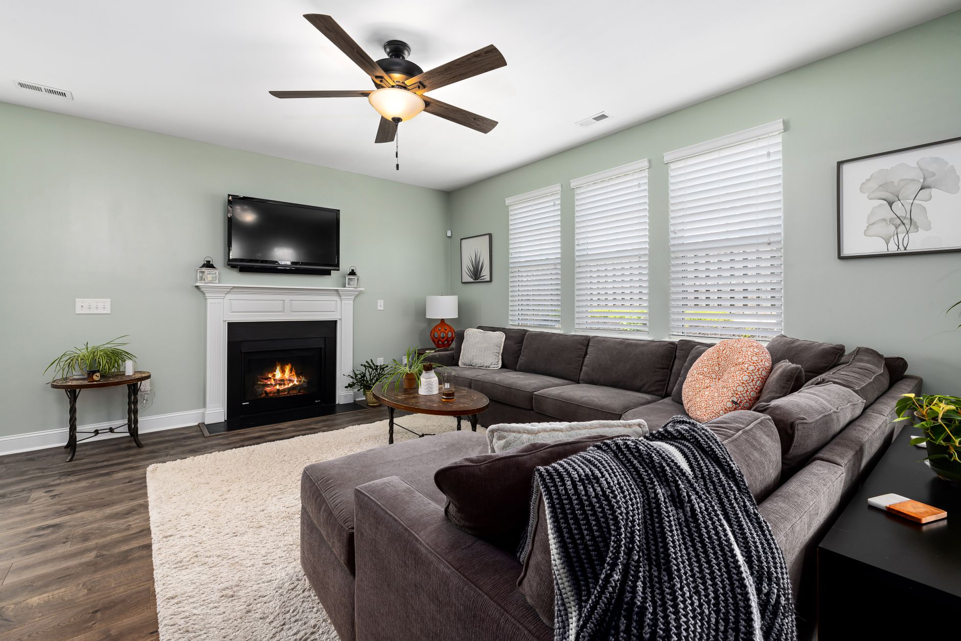 Spacious living room featuring a sectional sofa, fireplace, and modern decor.