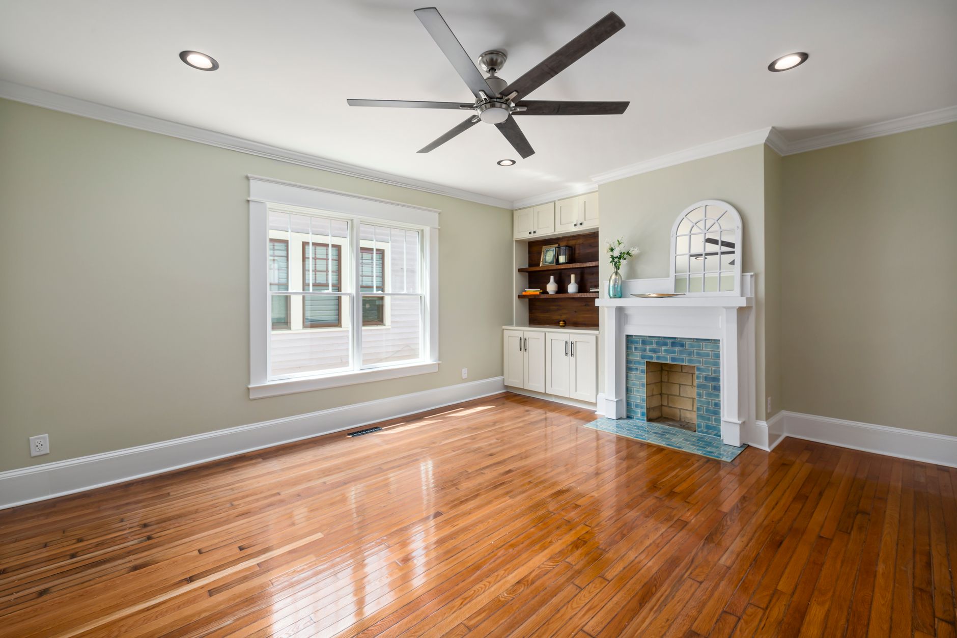 Spacious living room with hardwood floors and a contemporary fireplace.