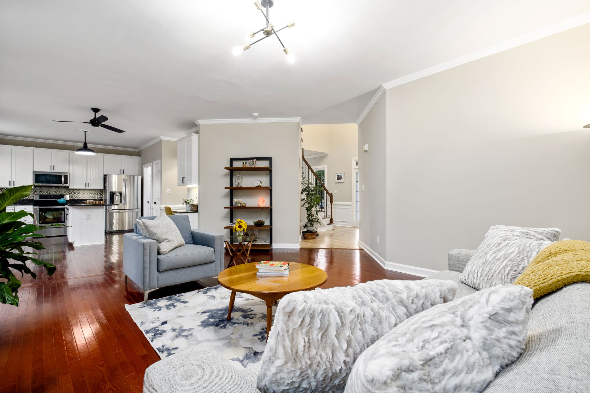 A real estate agent in San Antonio using virtual staging software on a laptop to stage a living room
