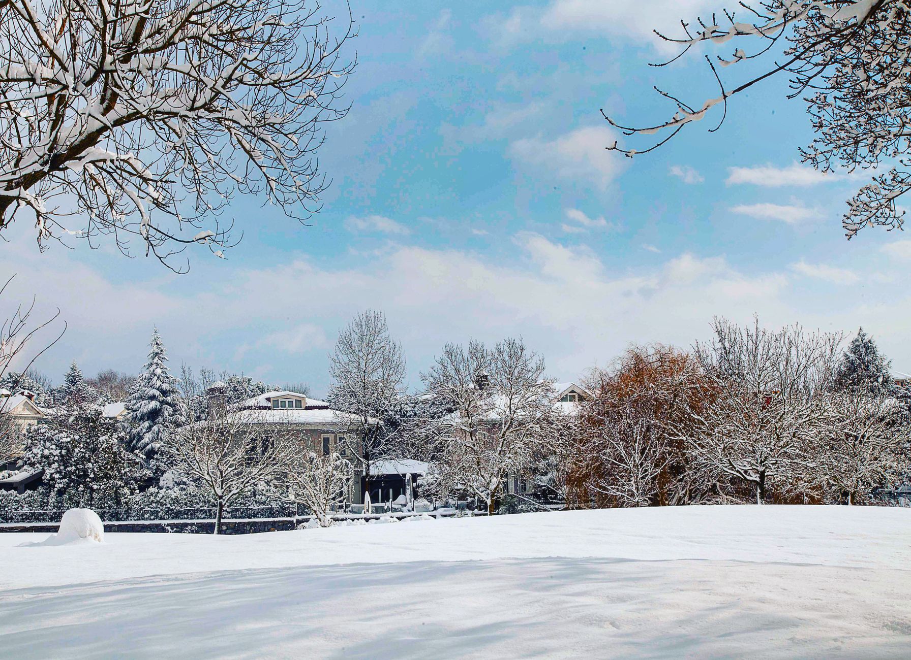 Side-by-side showing AI-converted summer to winter exterior