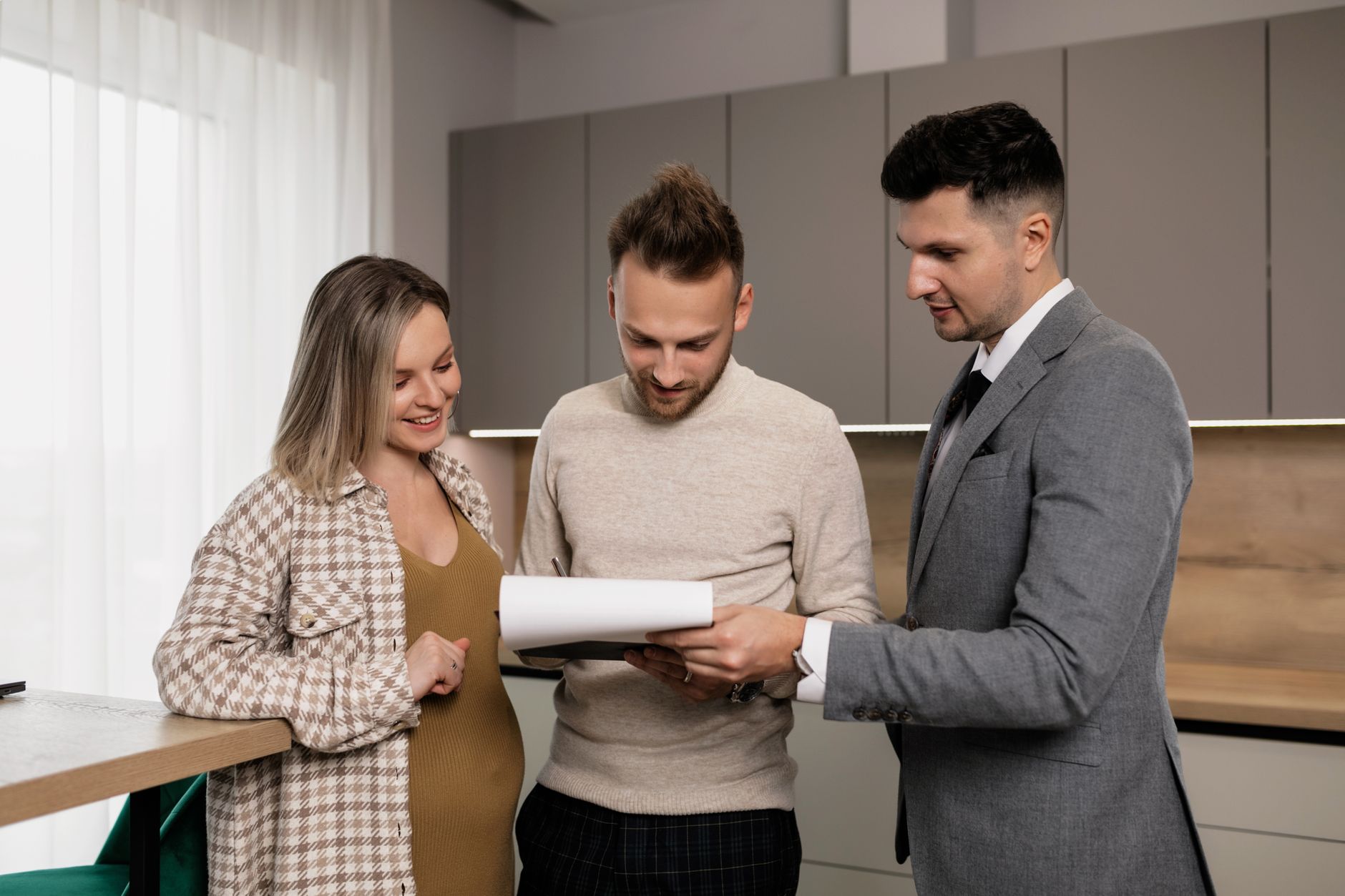 Professional realtor reviewing AI-enhanced property photos on digital tablet