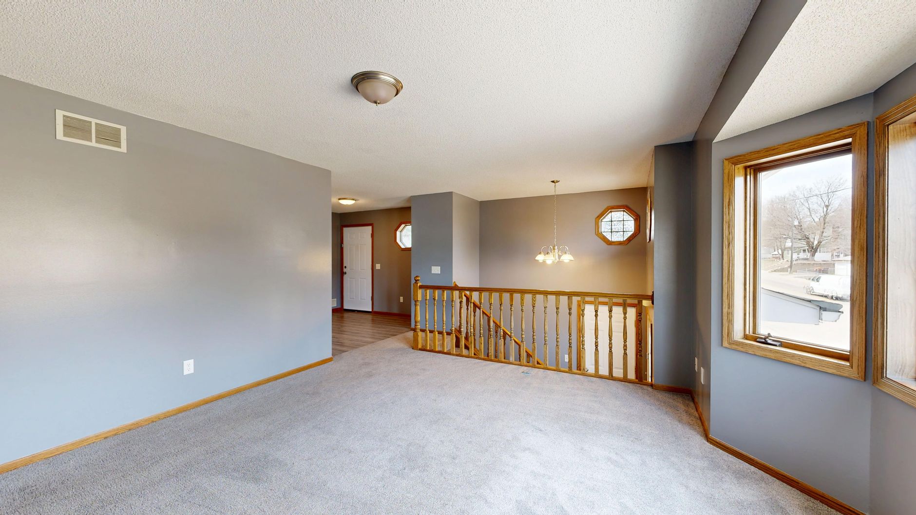 Empty living room being digitally staged with virtual furniture