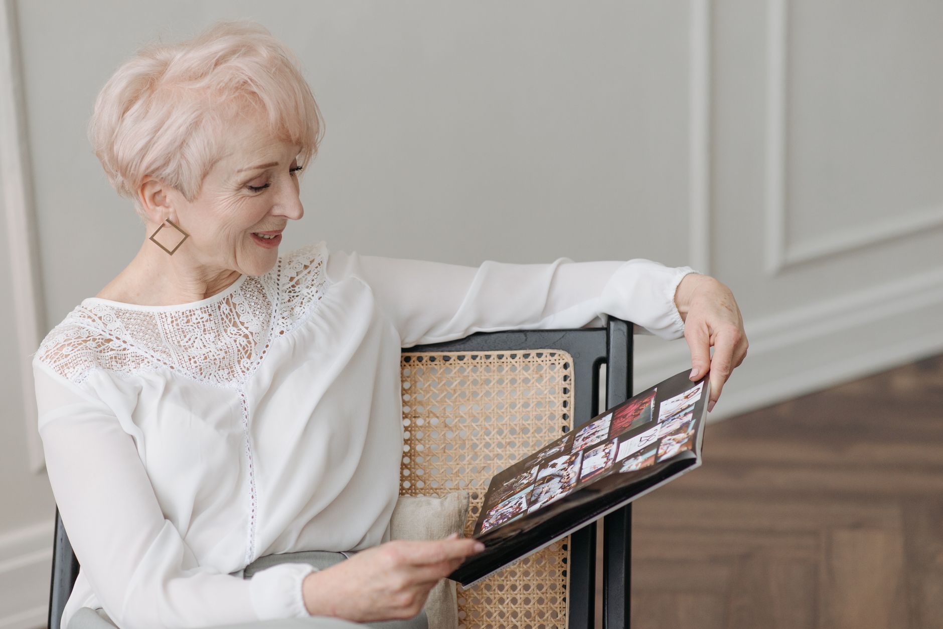 Professional real estate agent reviewing property photos on laptop