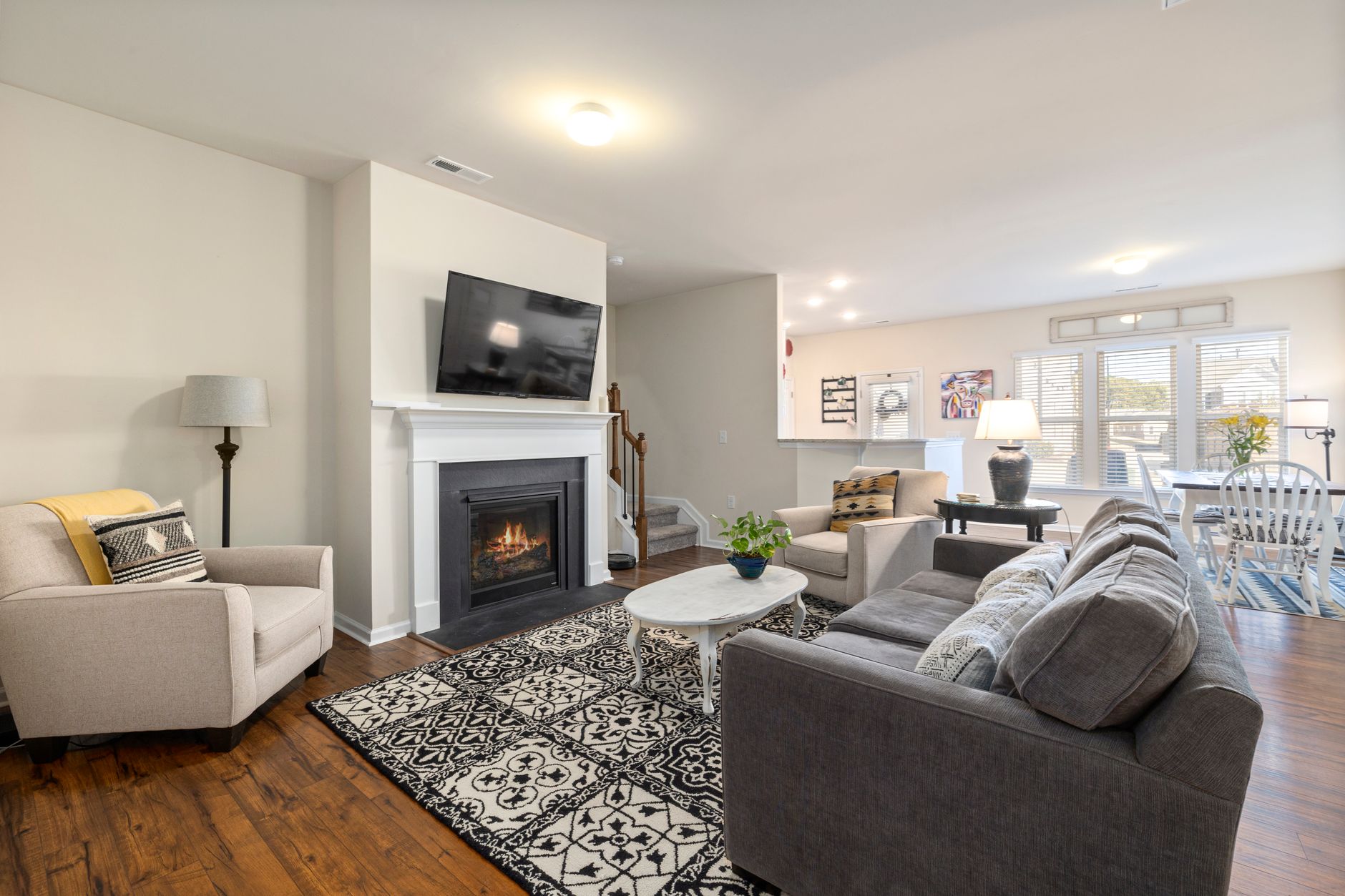Spacious living room featuring a fireplace, TV, and comfortable seating arrangement.