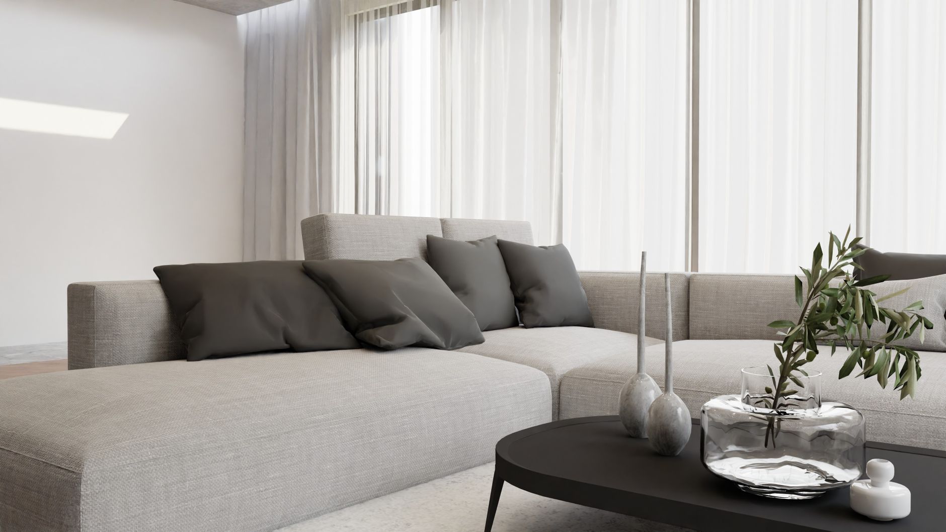Sleek contemporary living room featuring a gray sofa, black table, and decorative vase with greenery.