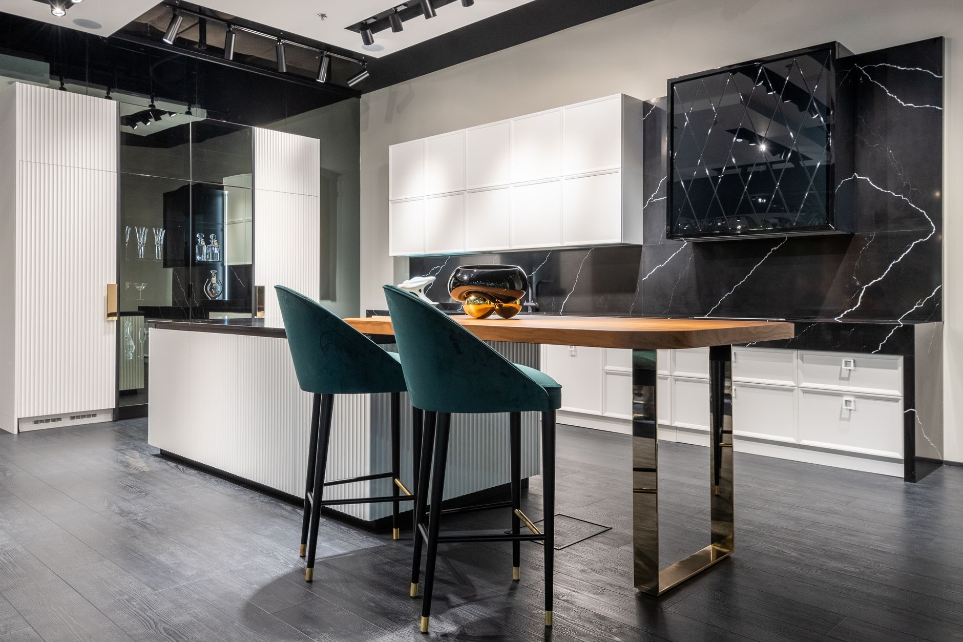 Contemporary trendy kitchen interior with black and white cabinets and cozy high chairs in modern apartment