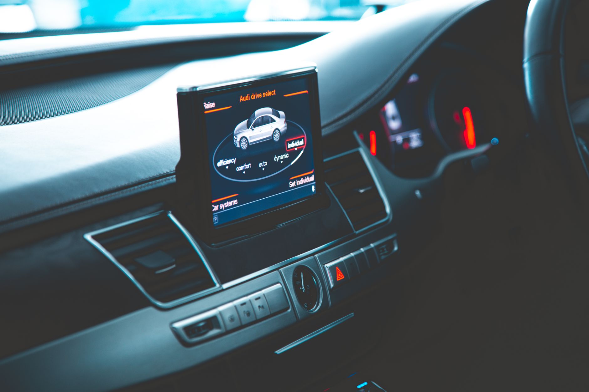 Close-up of a sleek Audi A8 interior highlighting the digital dashboard and multimedia display.
