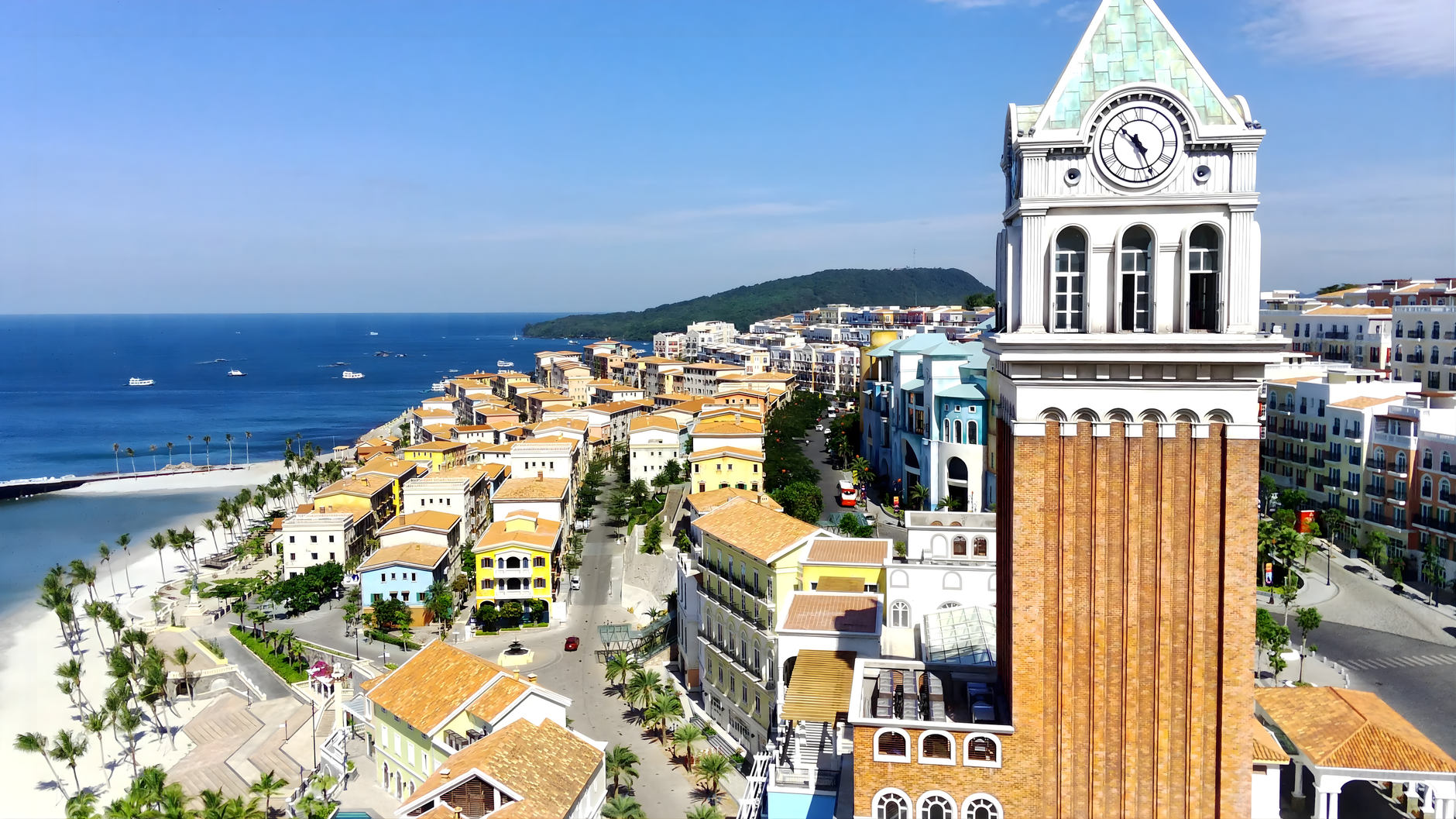 Aerial view of vibrant Phu Quoc town with iconic clock tower and scenic coast.