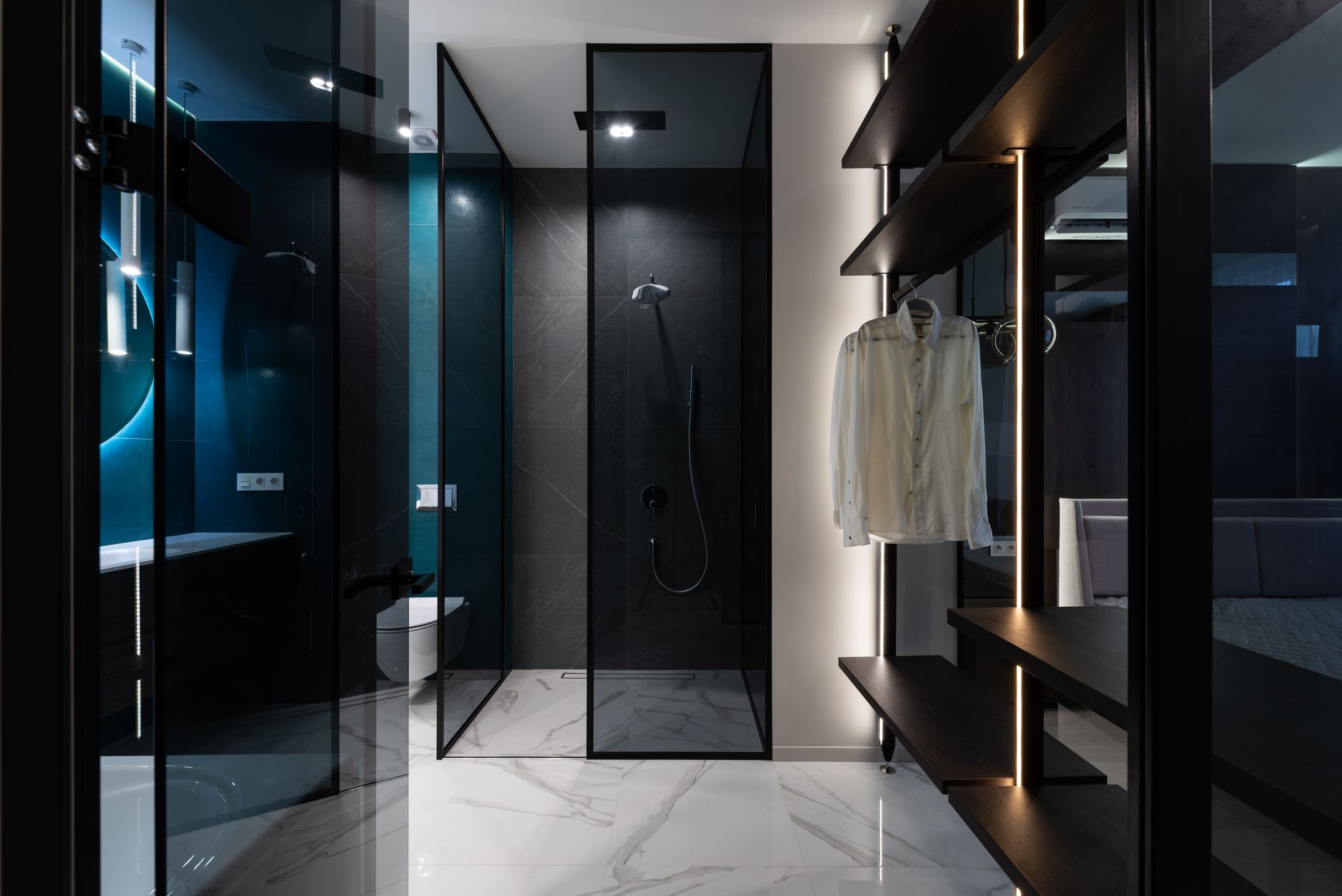 Modern wardrobe with wooden shelves in bedroom near bathroom with glass walls in trendy minimalist apartment