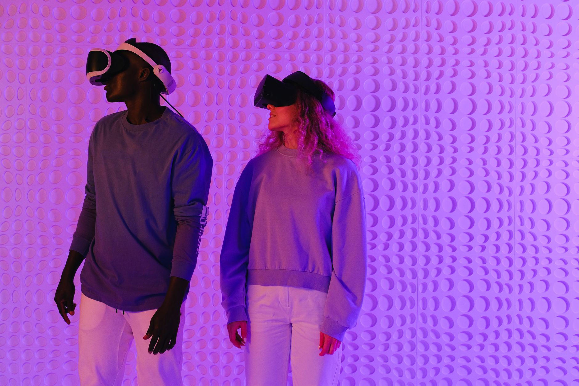 Two people immersed in virtual reality, highlighting modern technology and digital interaction.