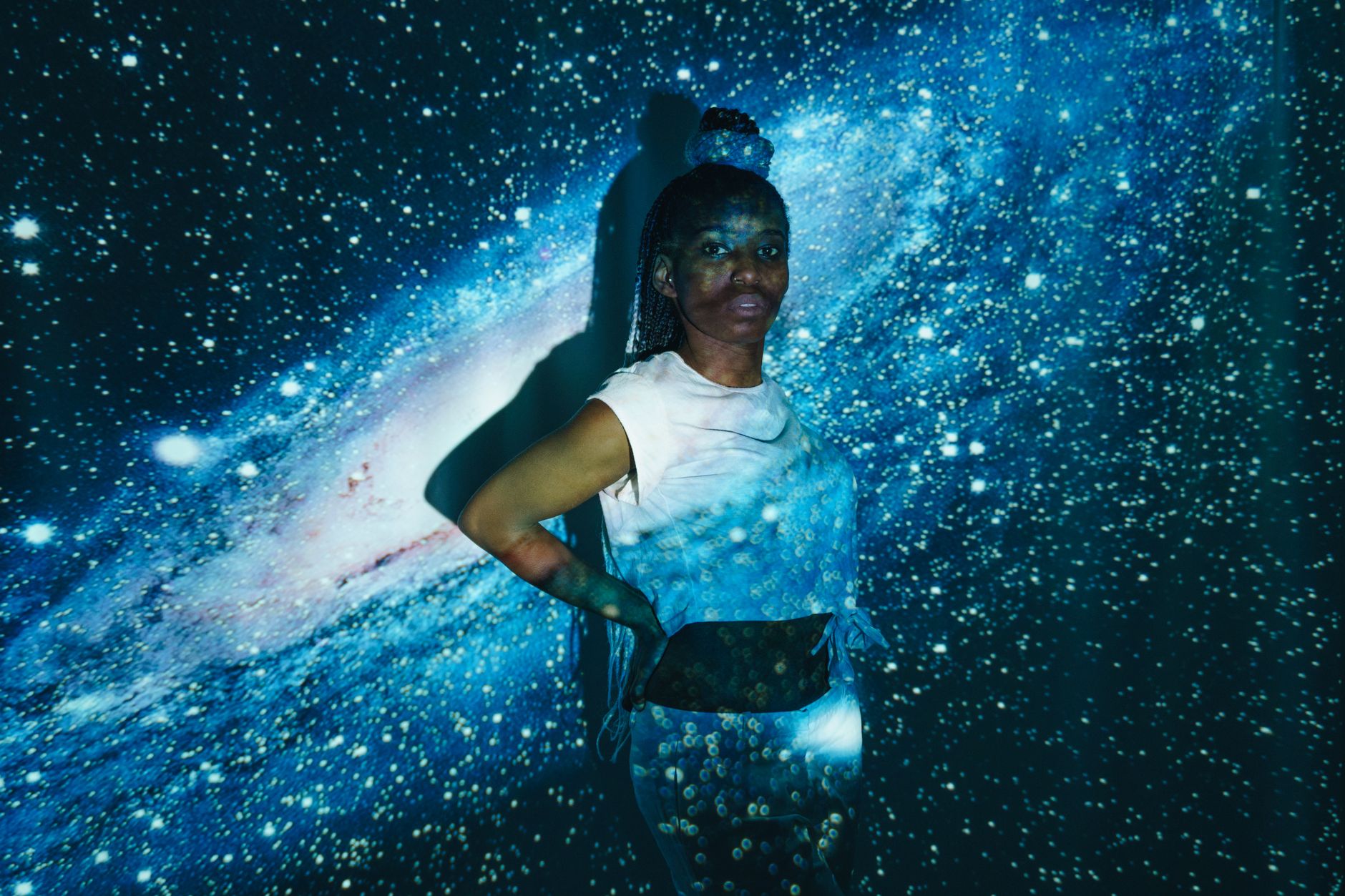 Abstract portrait of a woman with a cosmic starfield projection background in Erfurt, Germany.