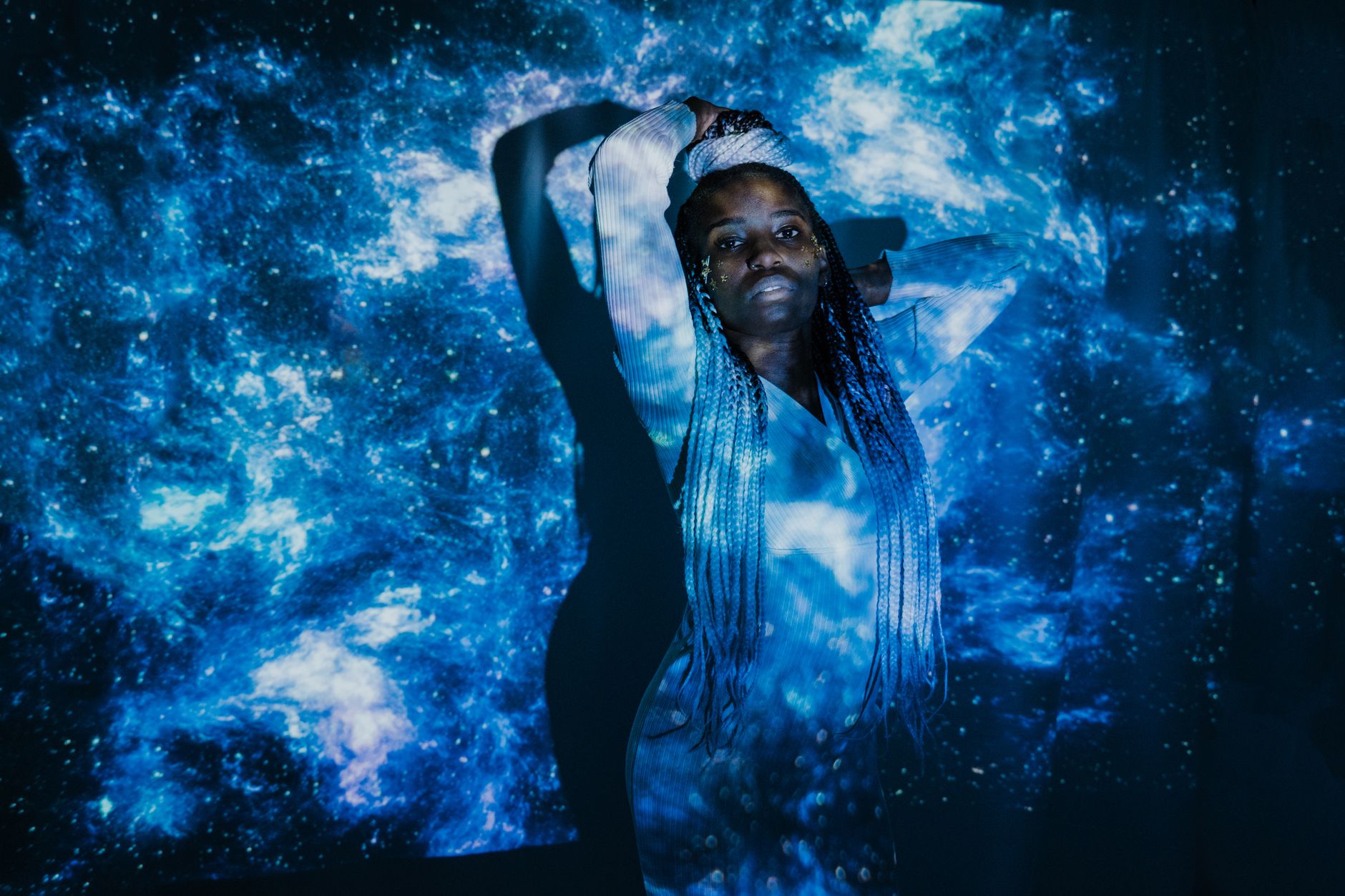 Captivating double exposure portrait blending a woman with a cosmic galaxy scene.