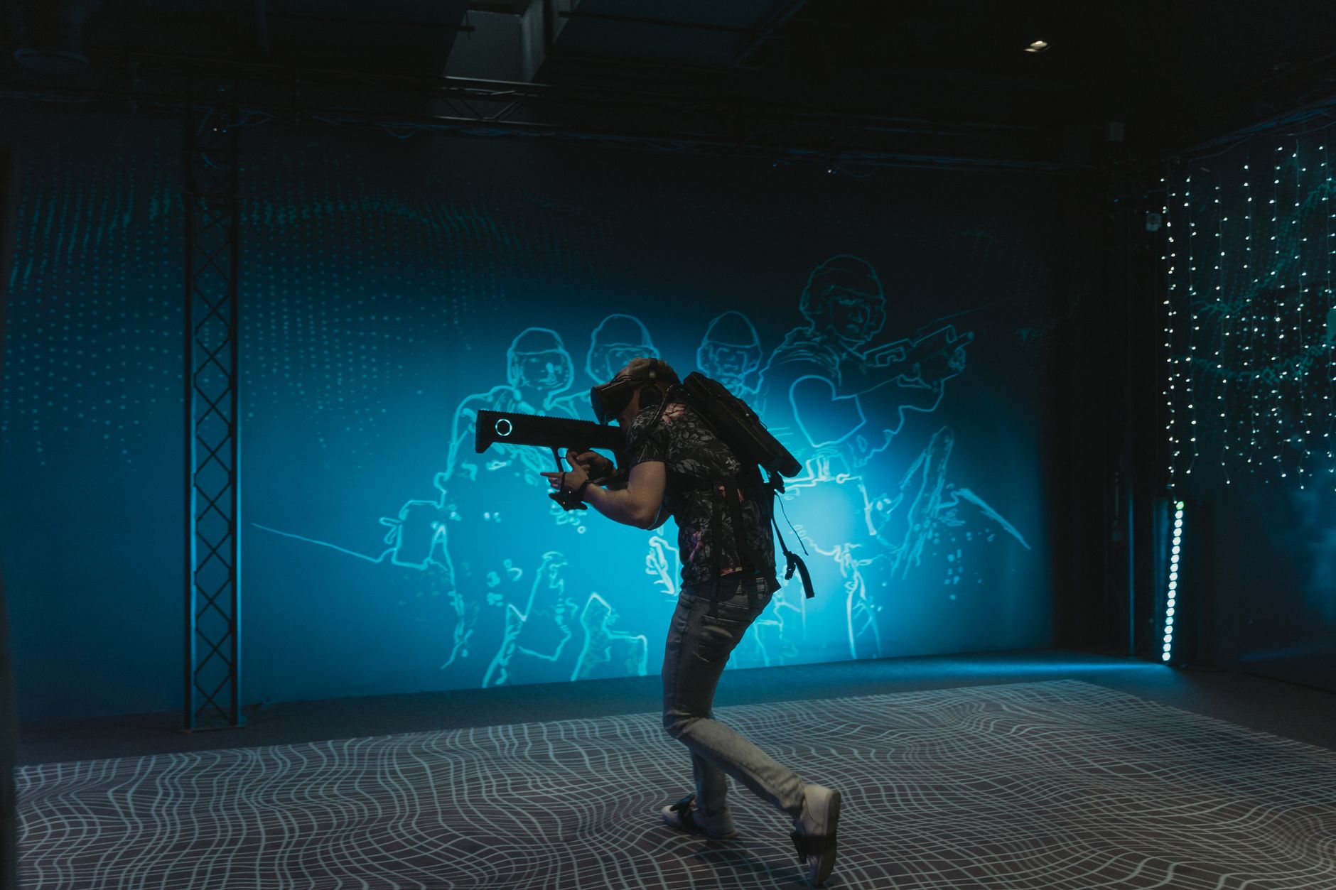 A person engages in immersive virtual reality gaming with VR gear indoors.