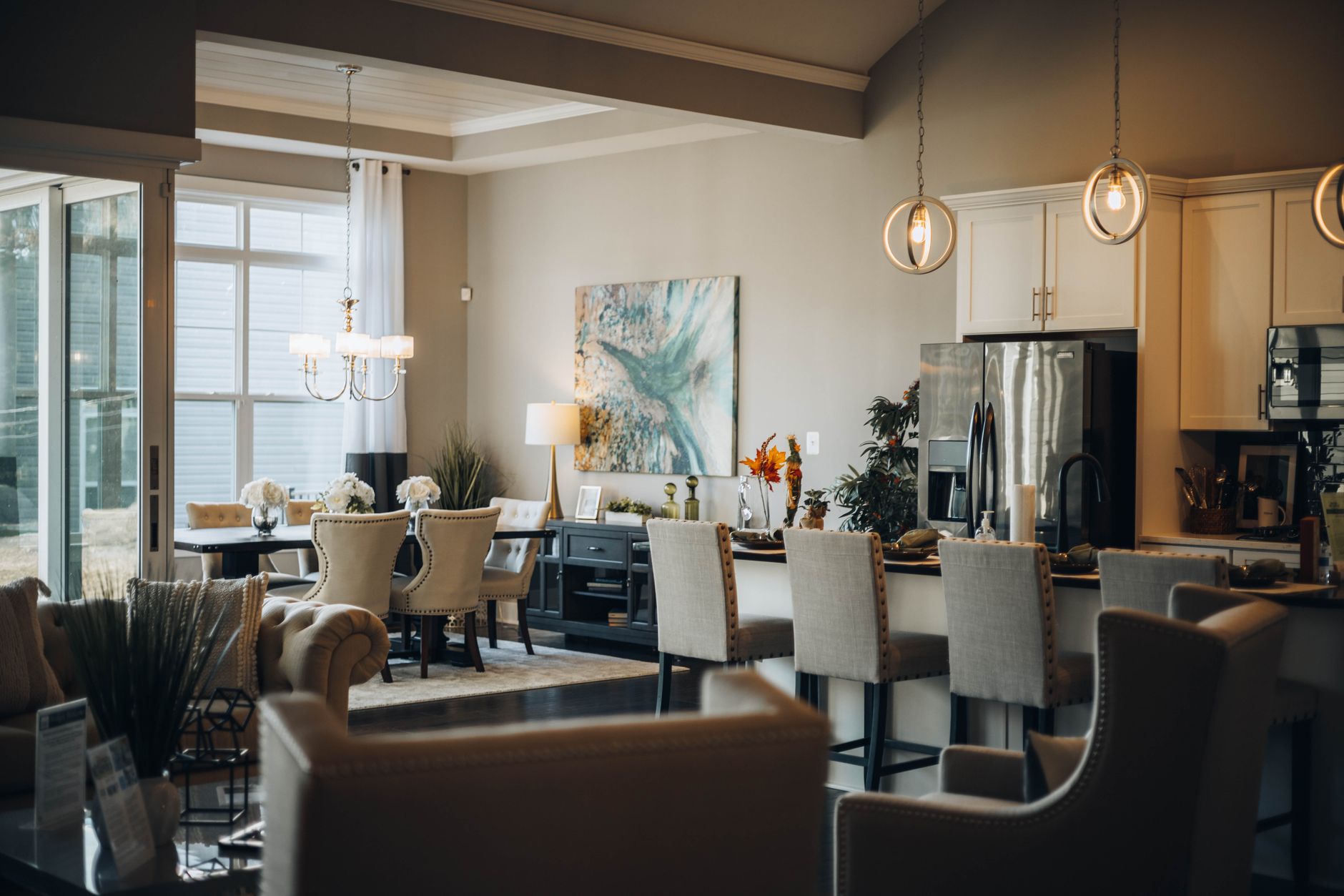 Modern open-concept dining and living area with neutral tones and elegant décor.