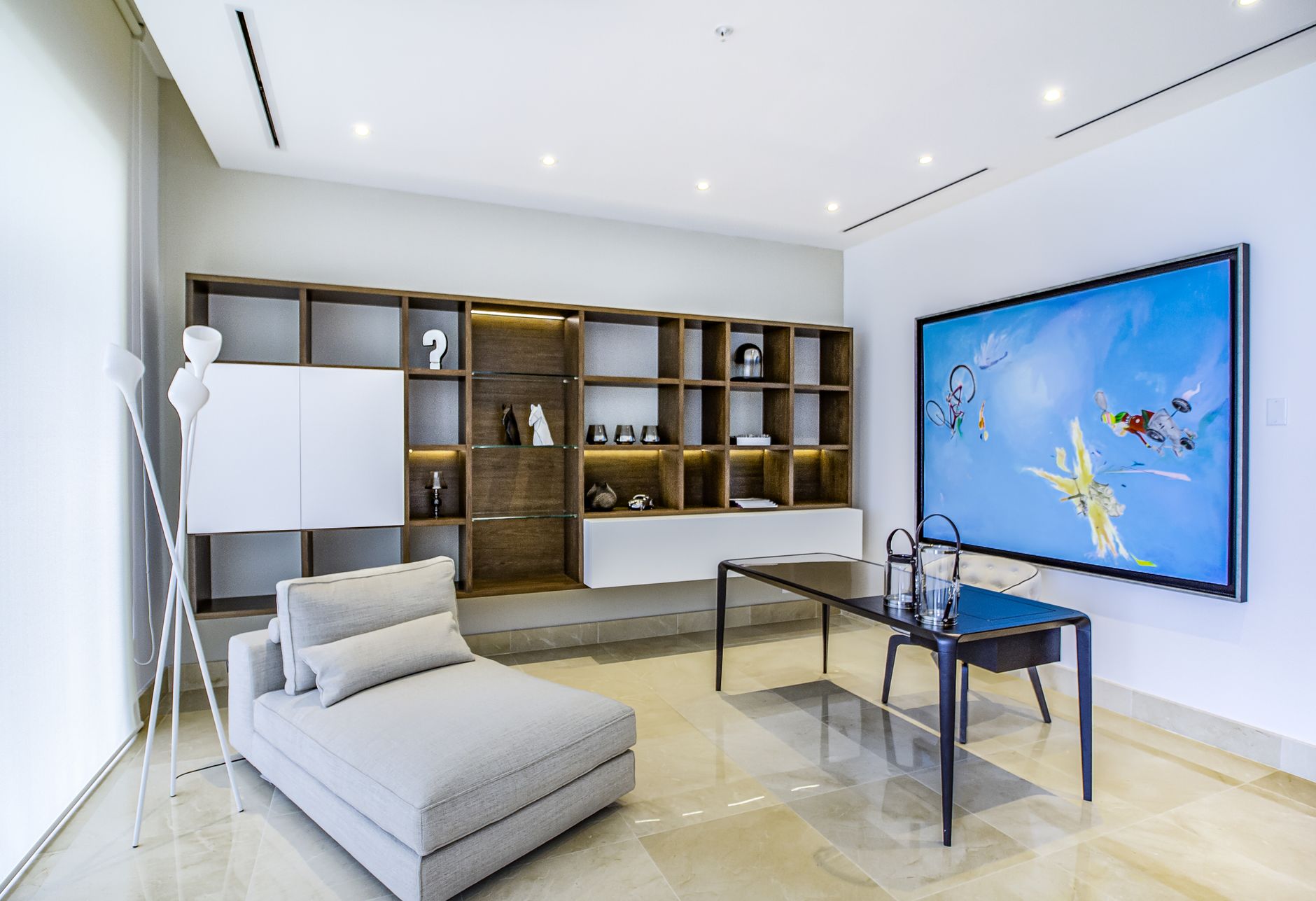 Sophisticated living room showcasing minimalist decor with abstract art and contemporary furniture.