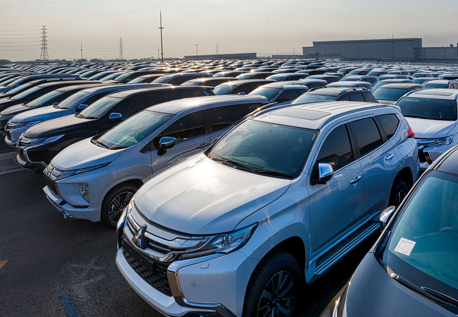 Modern prestige shiny cars in rows on asphalt parking of contemporary manufacture in daytime