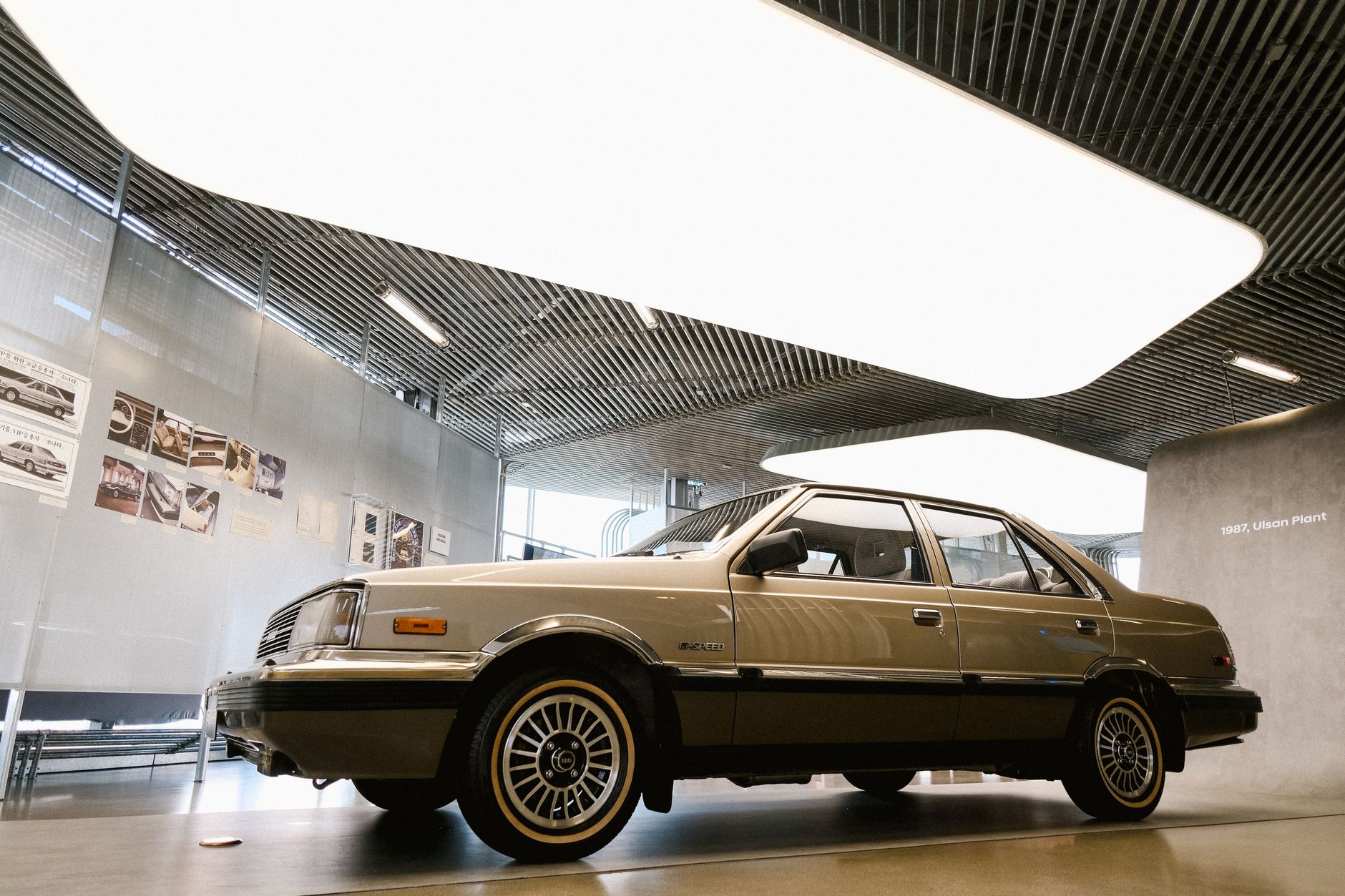 Vintage car displayed in a sleek, modern indoor showroom.