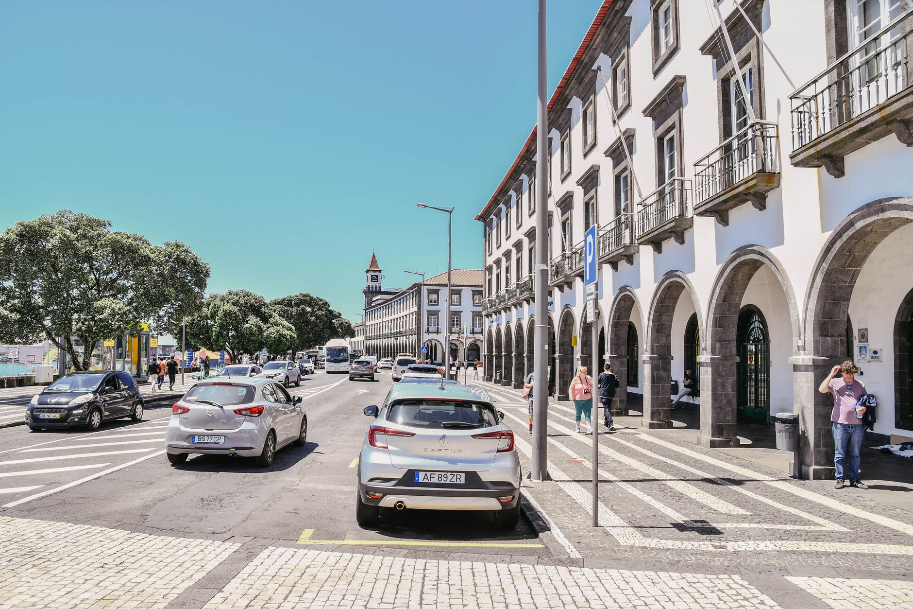Street view of Ponta Delgada with historic architecture and bustling afternoon activity.