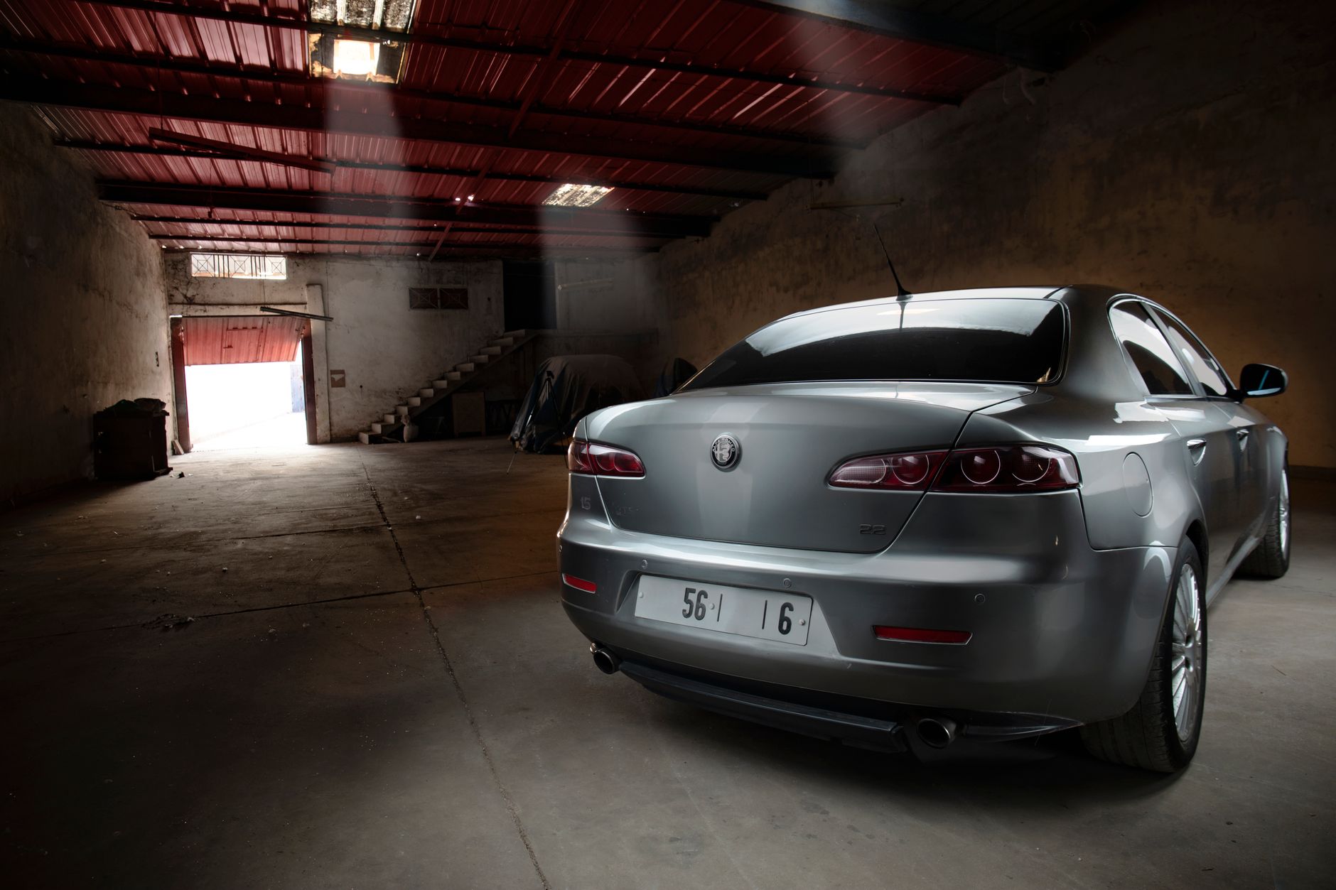 Sleek luxury car in a rustic garage setting, showcasing elegance in Casablanca