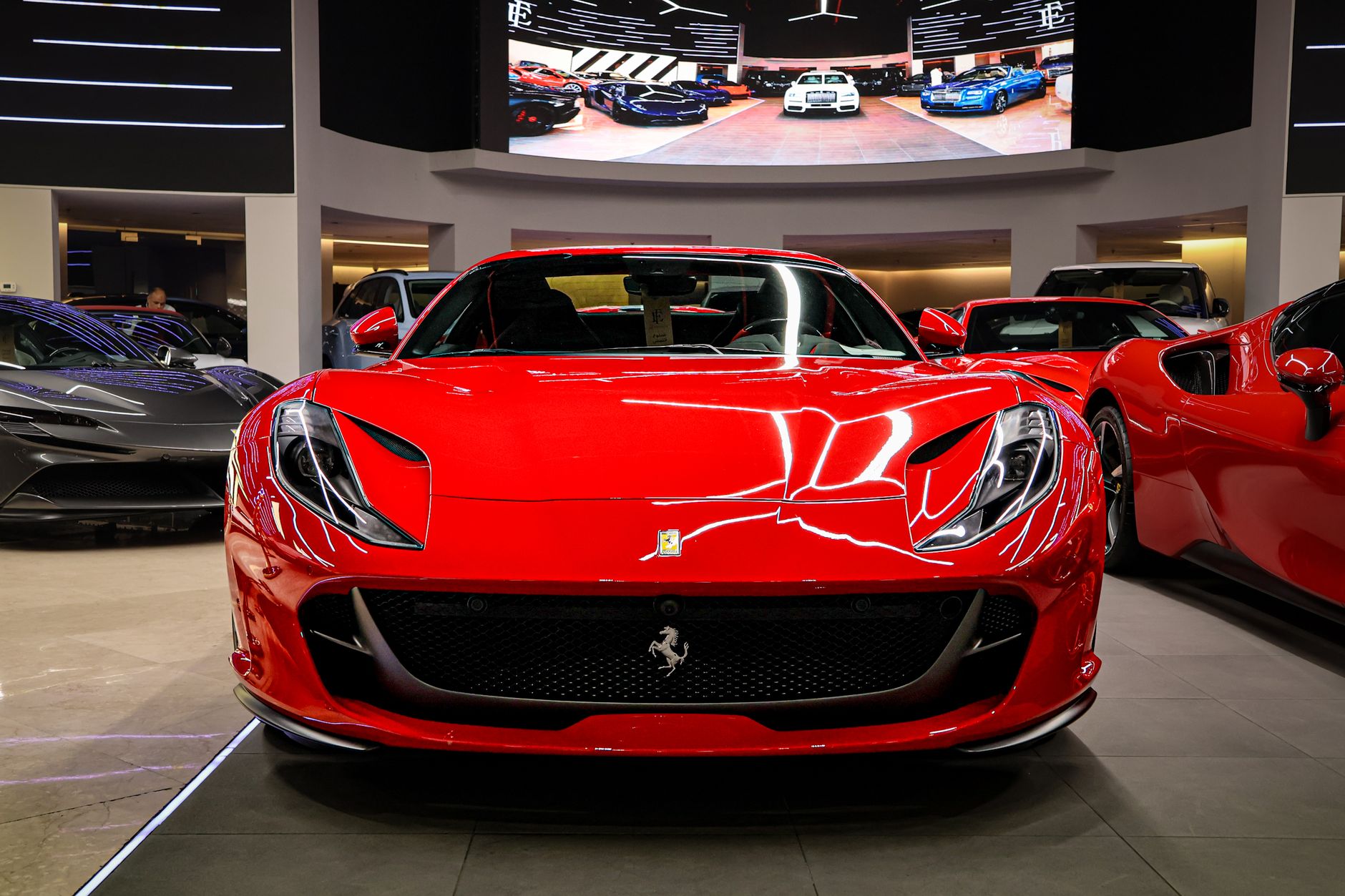 Bright red sports car displayed indoors showcasing luxury and style.