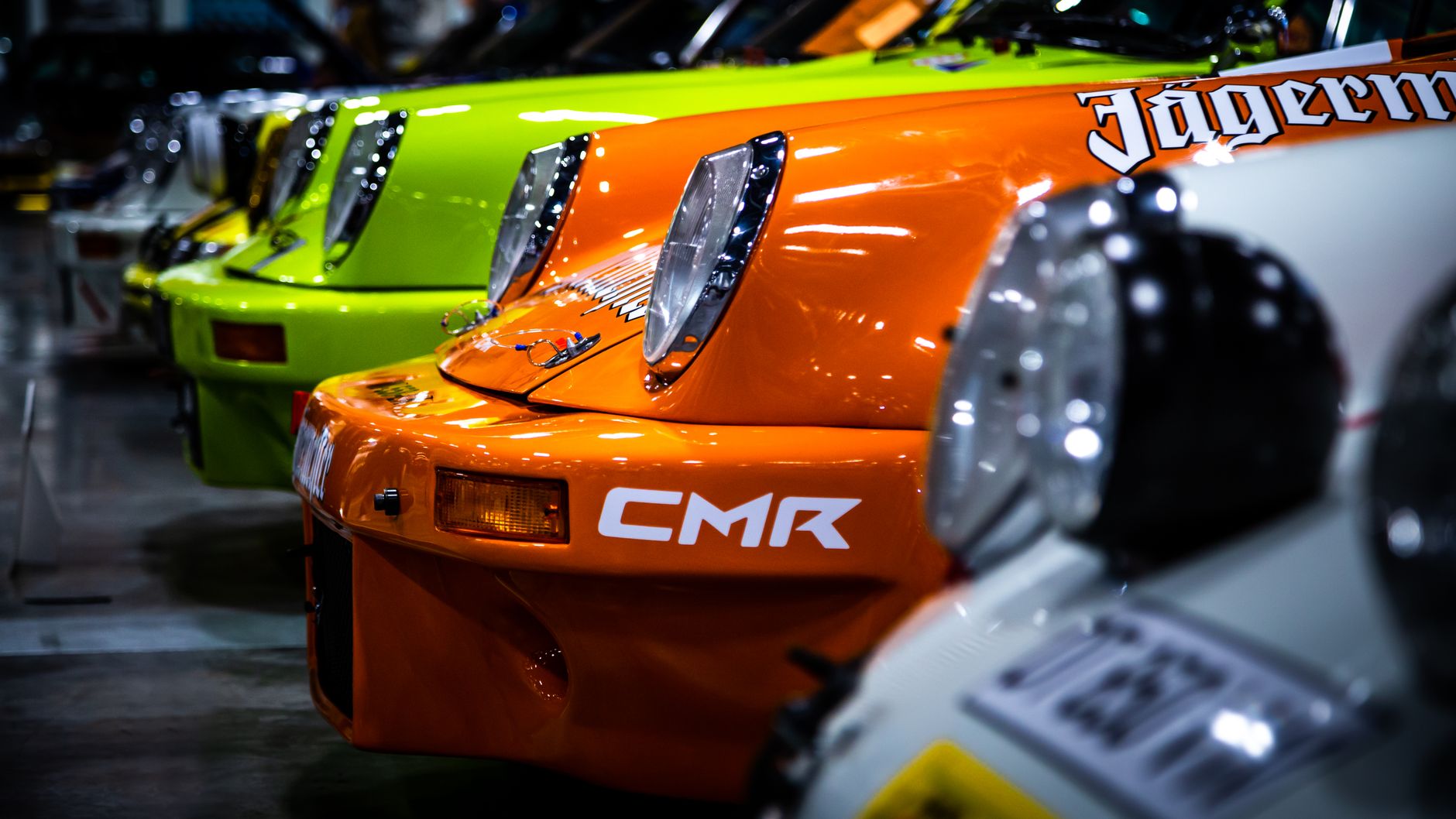 Detailed close-up of vibrant vintage sports cars in a row.