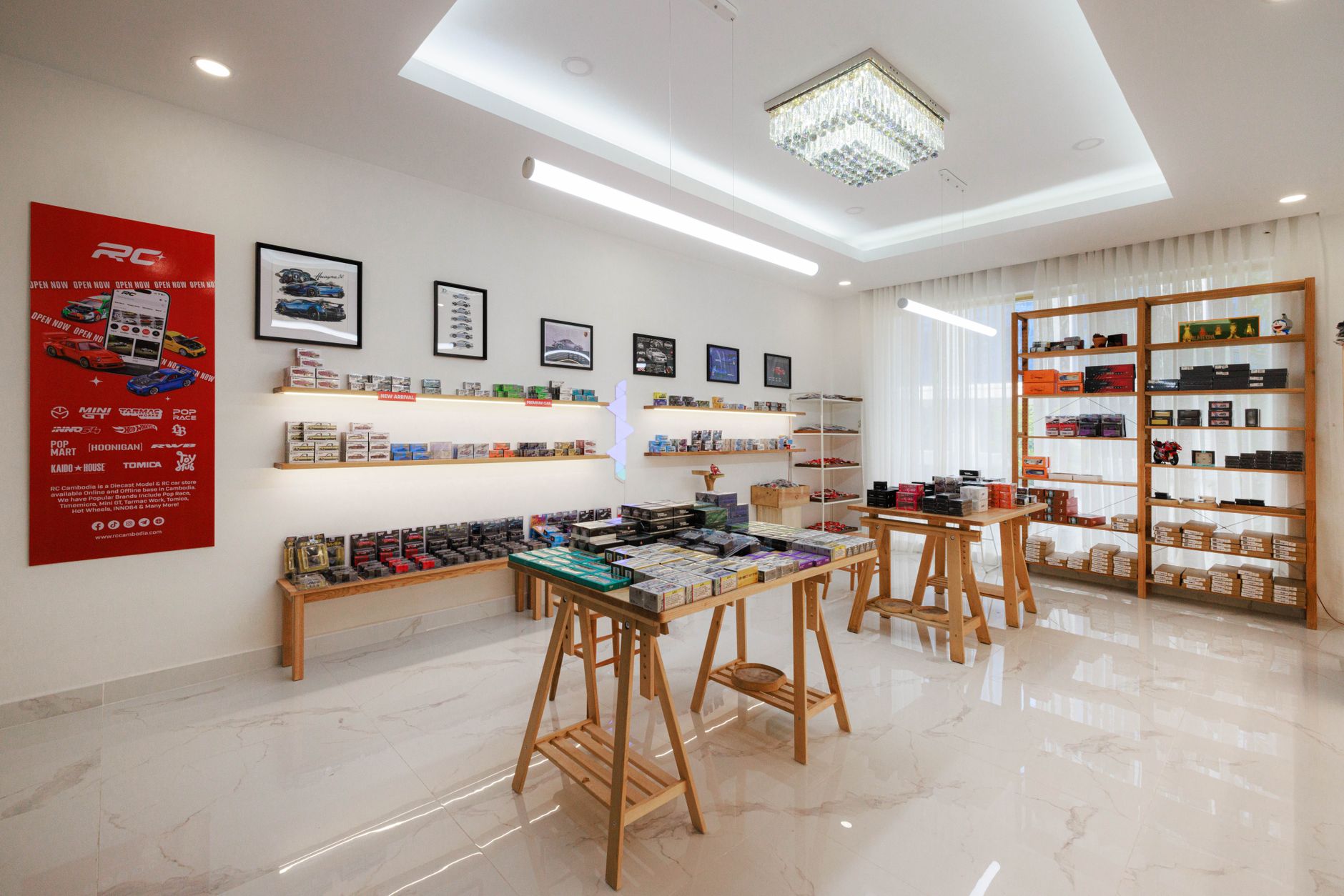 Interior of a sleek diecast and RC model store in Phnom Penh, showcasing various model cars and store design.