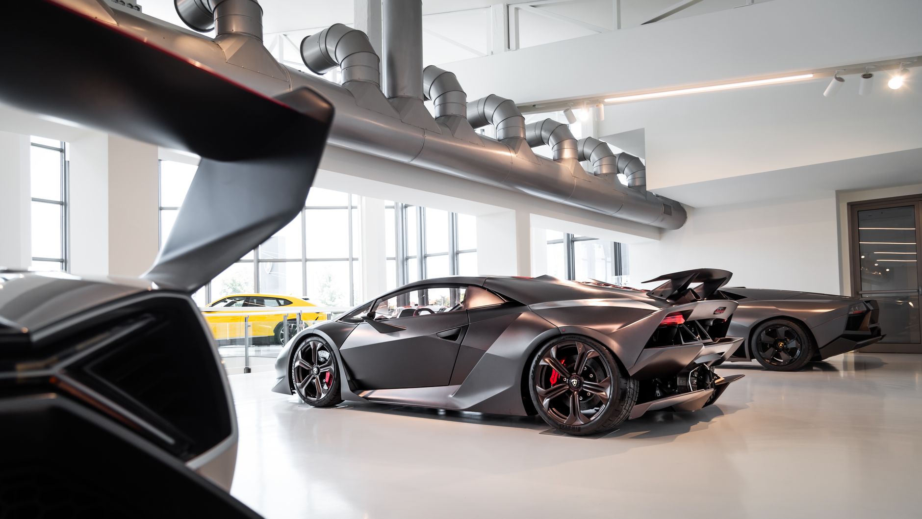 Capture of sleek Lamborghini supercar on display in a modern showroom, highlighting luxury and style.