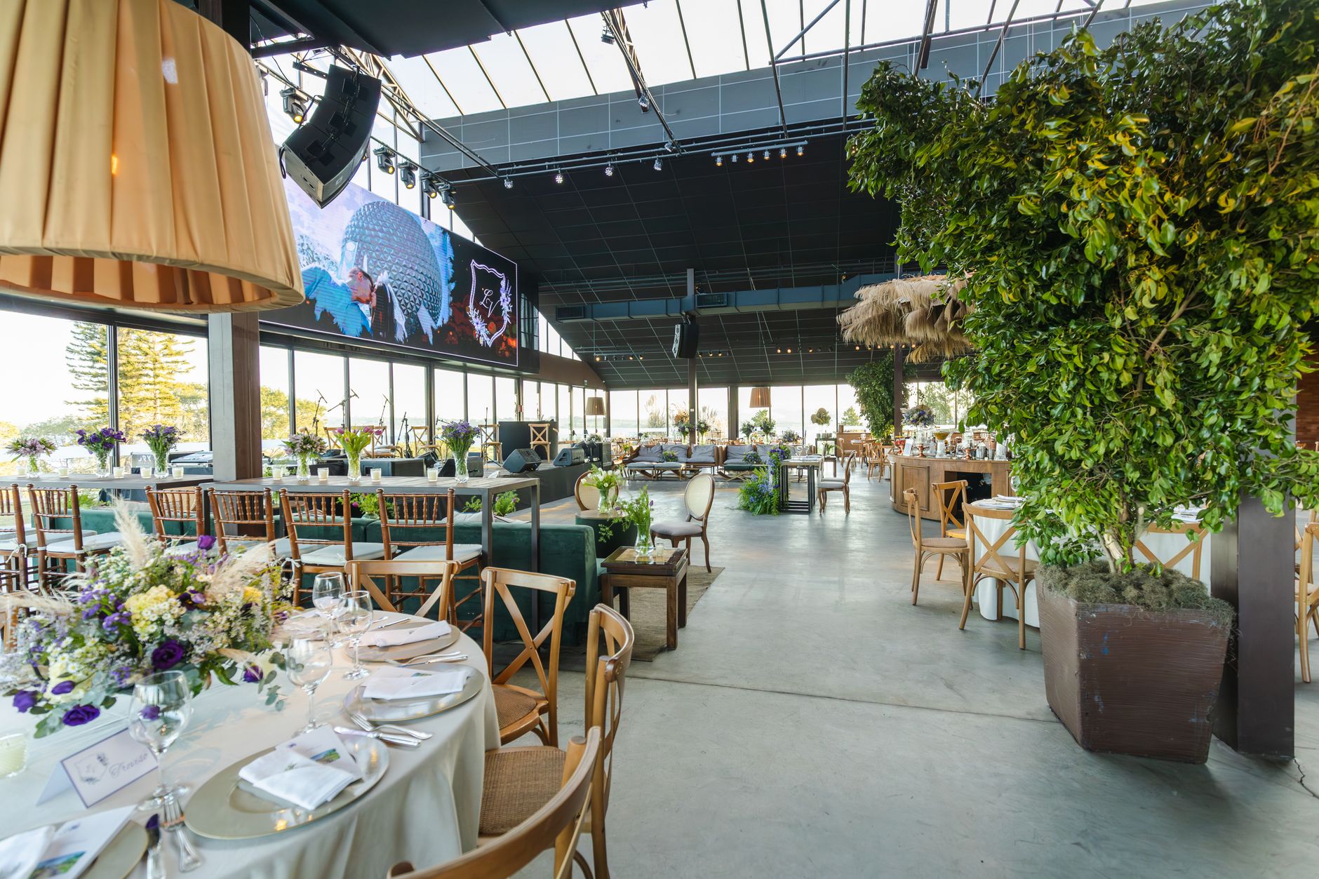 A beautifully decorated indoor reception venue with floral arrangements and elegant table settings.