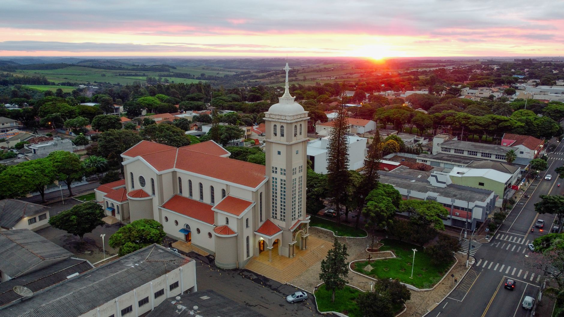 A stunning aerial view of Mandaguari, Brazil, featuring the cathedral at sunset.