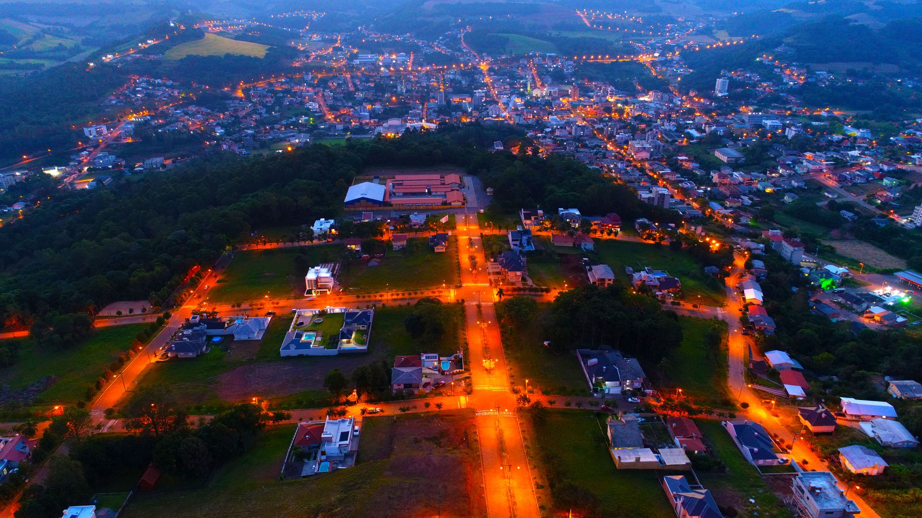 Illuminated aerial view of Centro, Brazil showcasing streets and buildings at dusk.