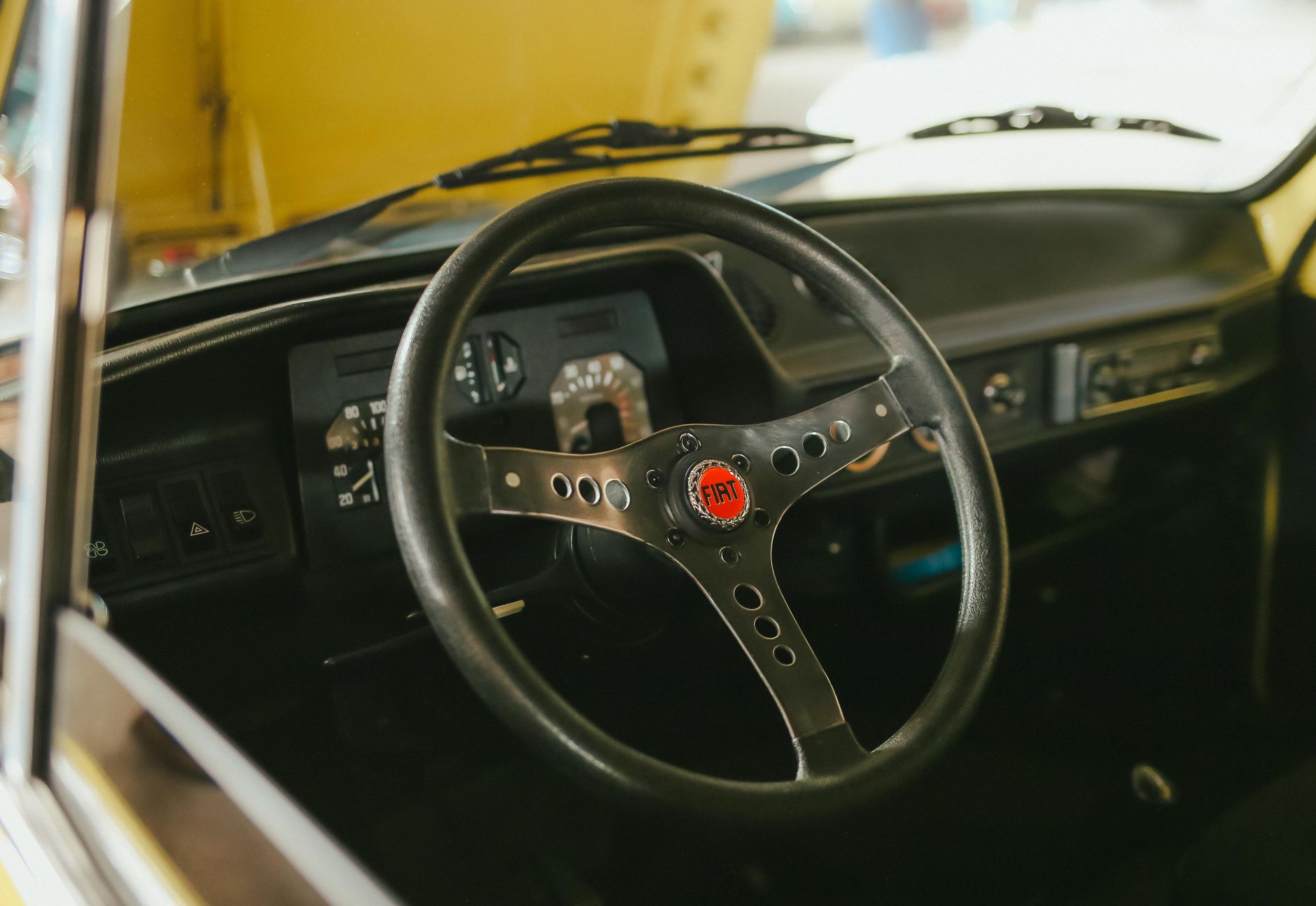 Interior view of a classic Fiat car with steering wheel and dashboard in Presidente Prudente, Brazil.