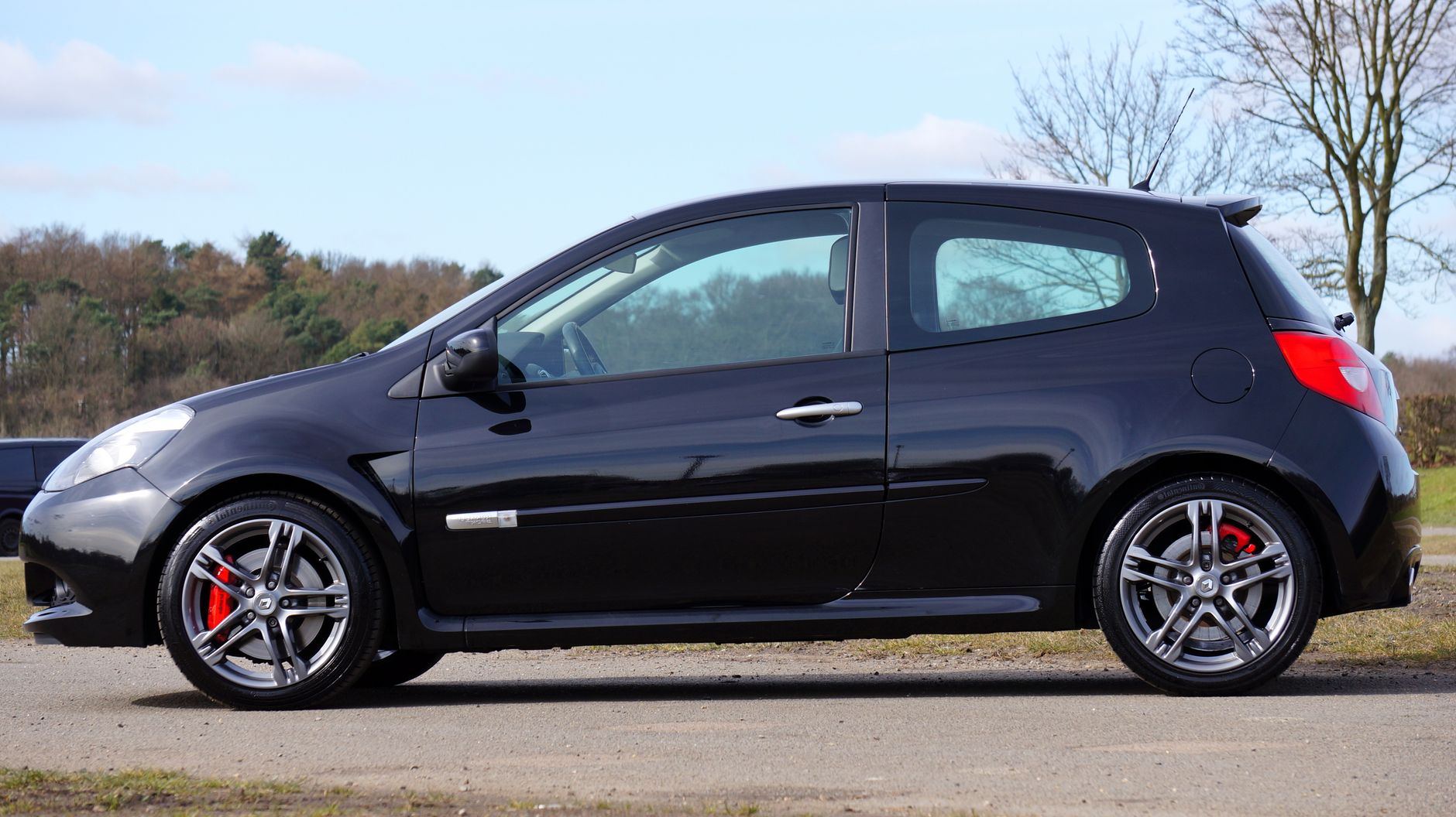 A modern Renault Clio RS hot hatchback parked in a scenic outdoor setting.