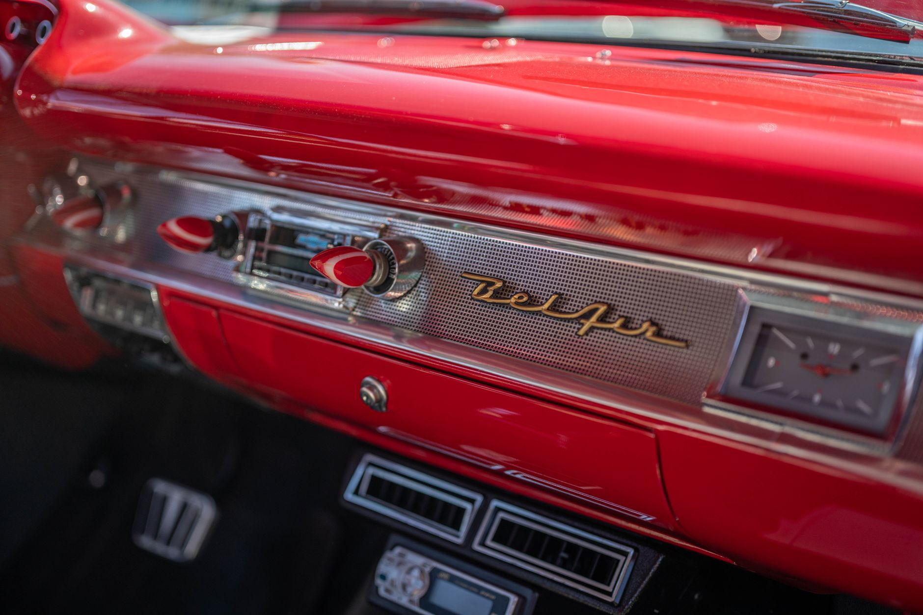 Close-up of a vintage 1950s Chevrolet Bel Air dashboard with retro design and chrome details.