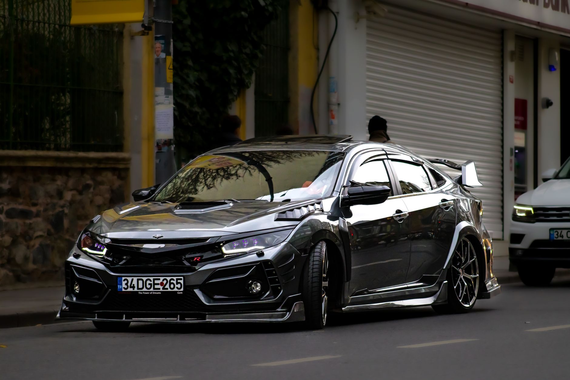 Dynamic shot of a Honda Civic Type R in the city, showcasing modern automotive design.