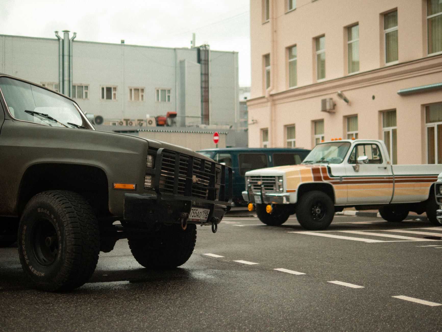 Classic pickup trucks parked on a city street in Saint Petersburg, Russia, showcasing a vintage urban scene.