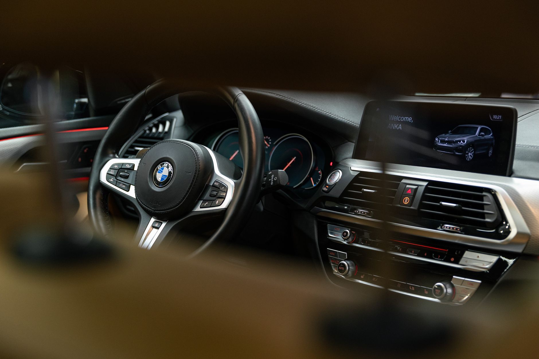 Detailed view of a BMW car interior showcasing the dashboard and steering wheel.