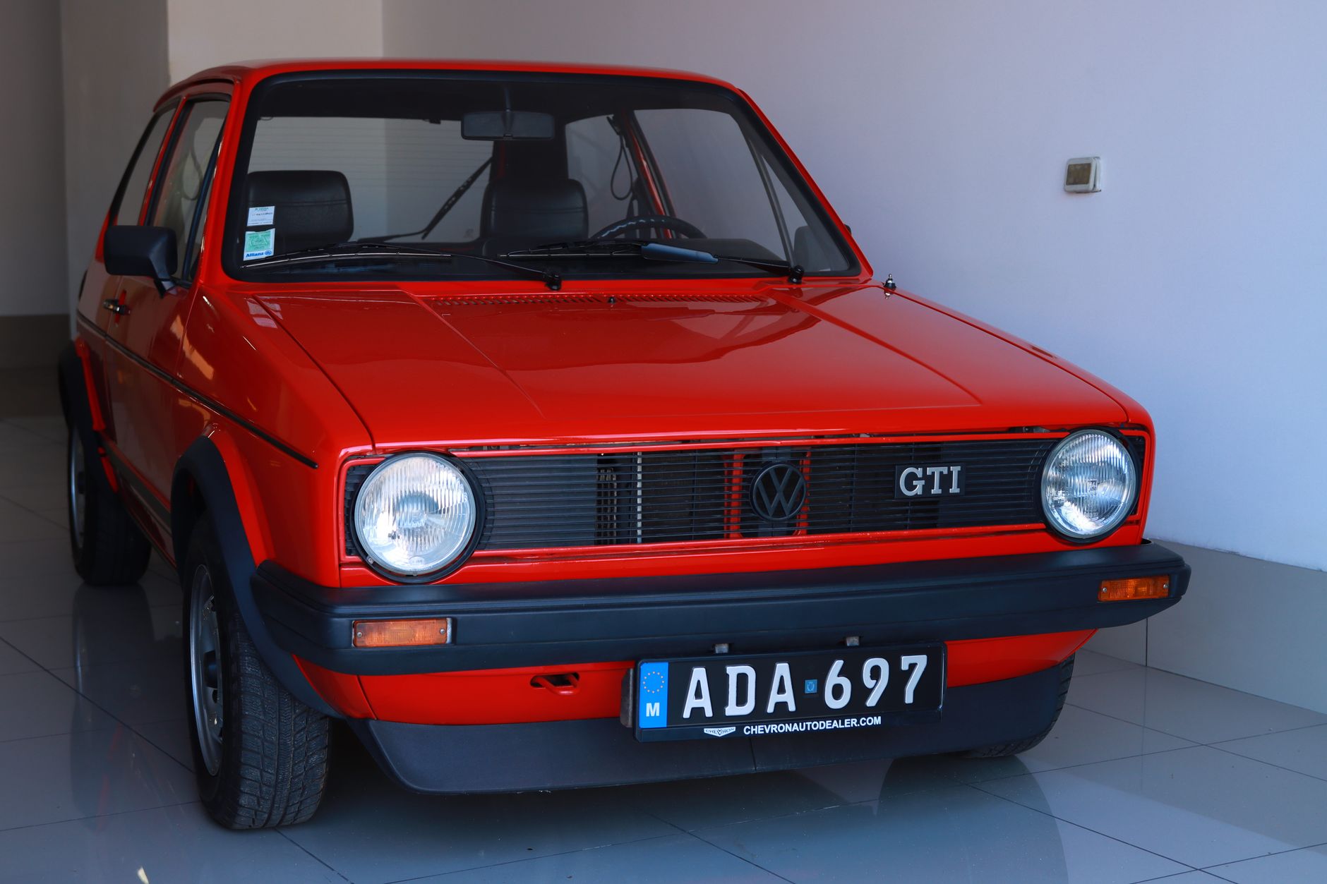 Vintage Volkswagen Golf GTI parked indoors with Malta license plate.