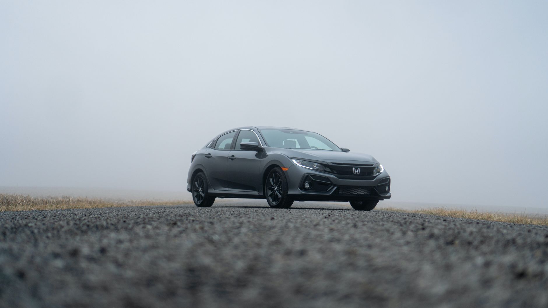 A sleek Honda Civic parked on a foggy day in Fort Wayne, Indiana.