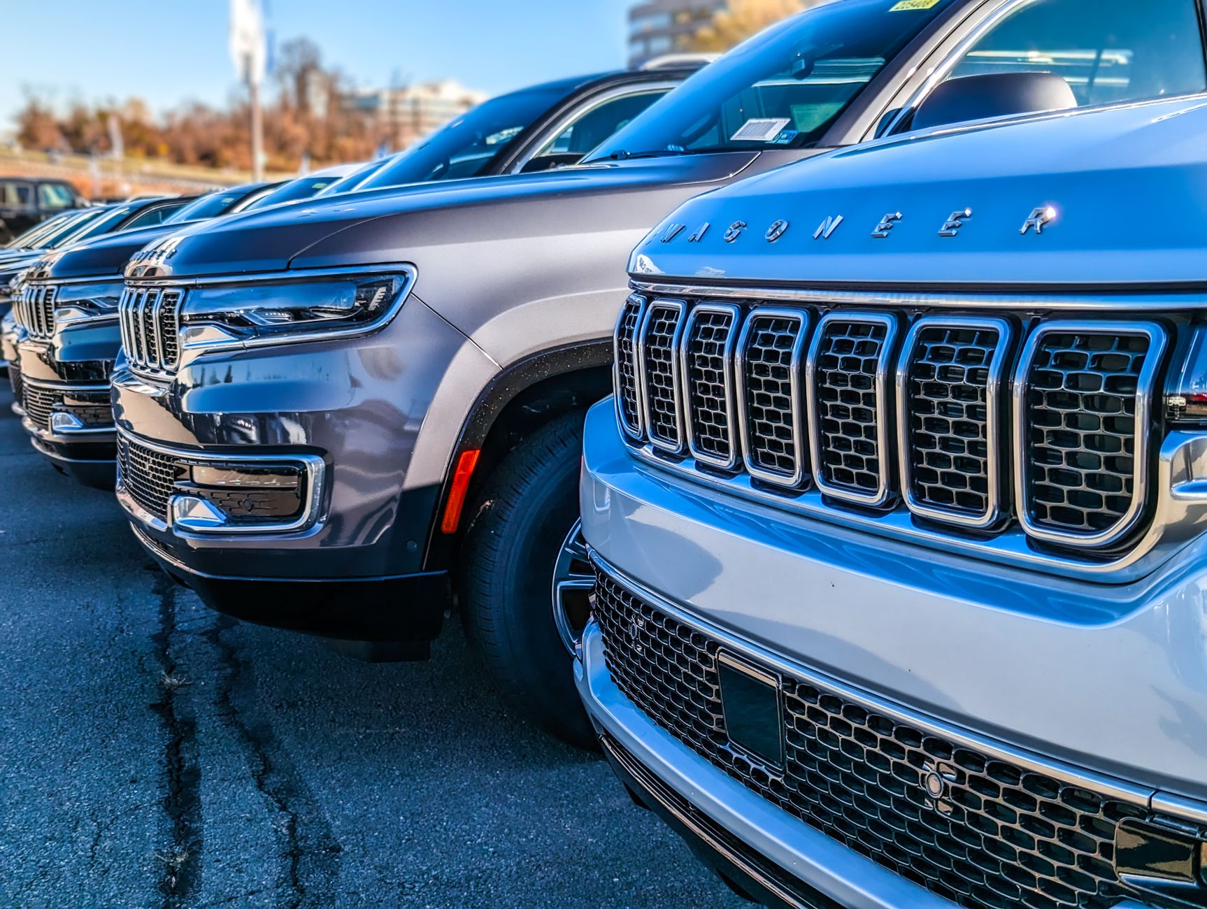 Close-up view of modern SUVs parked in a dealership lot.