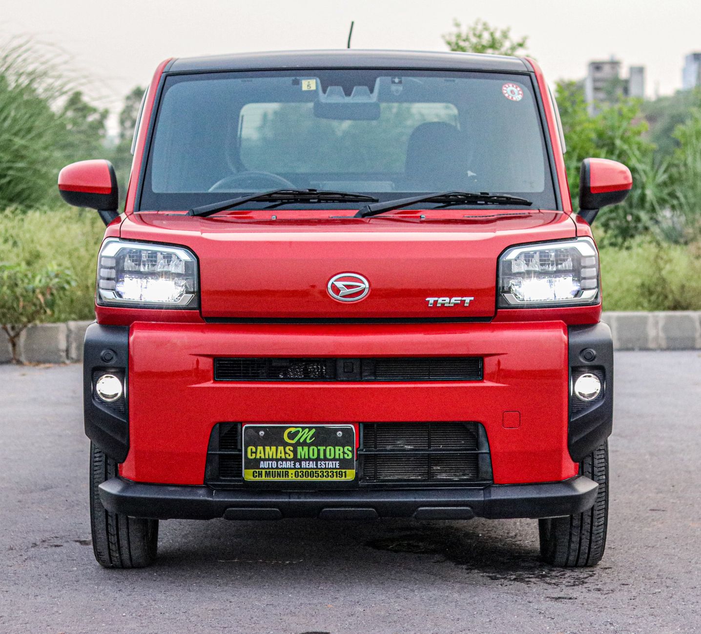Front view of a red Daihatsu Taft SUV parked outdoors in Rawalpindi, Pakistan.