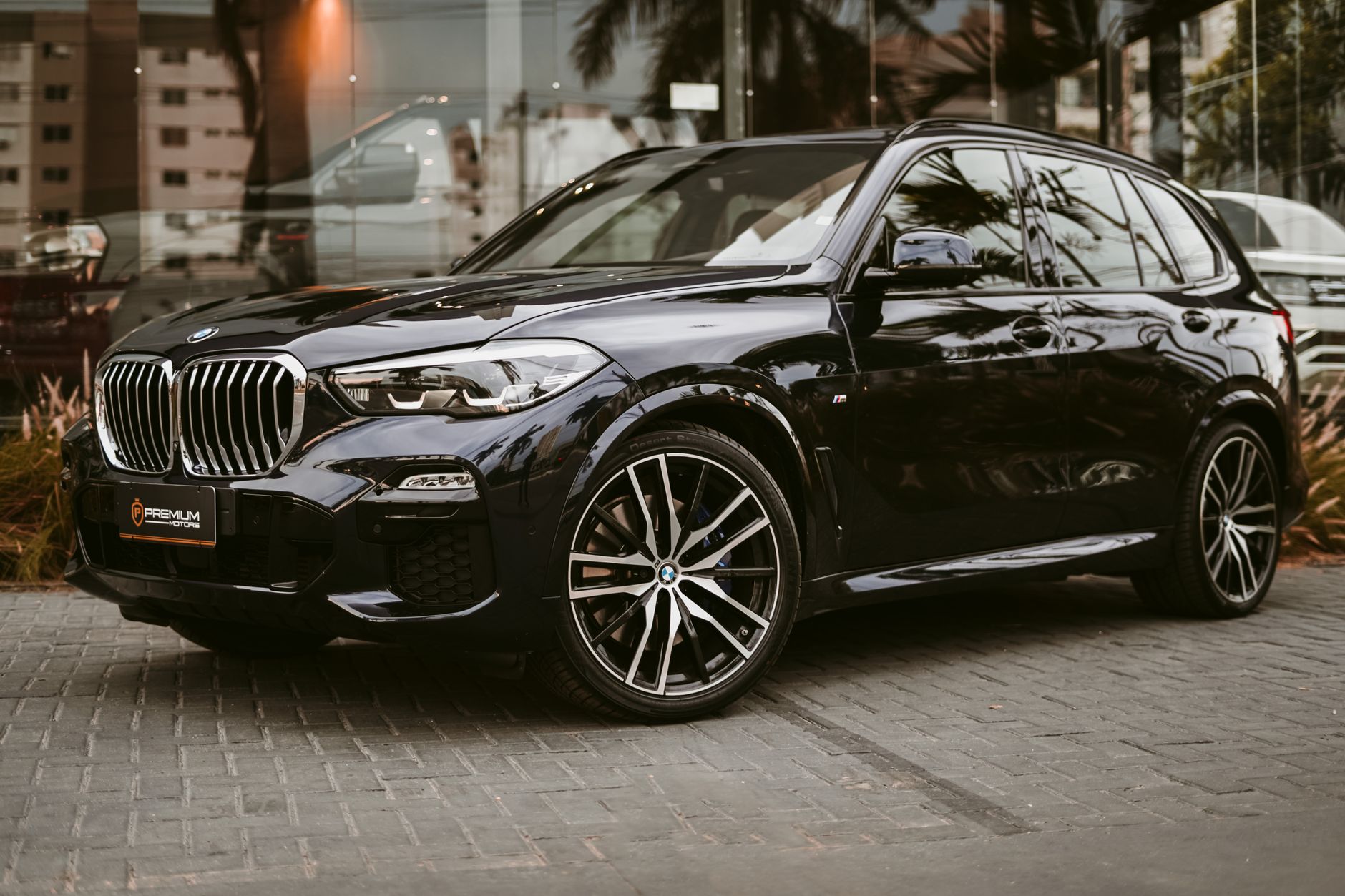 A sleek black luxury SUV parked in an urban setting, showcasing its elegance.