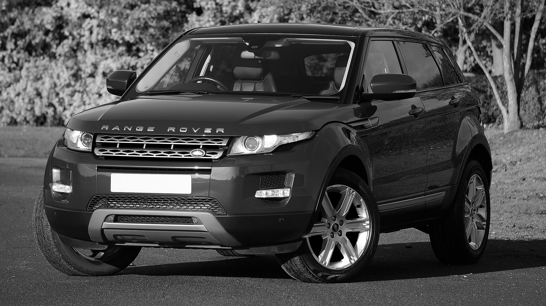 Elegant black and white photo of a parked SUV displaying sleek design and style.