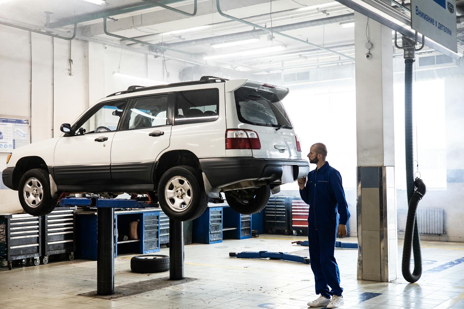 Mecânico inspecionando SUV seminovo em oficina