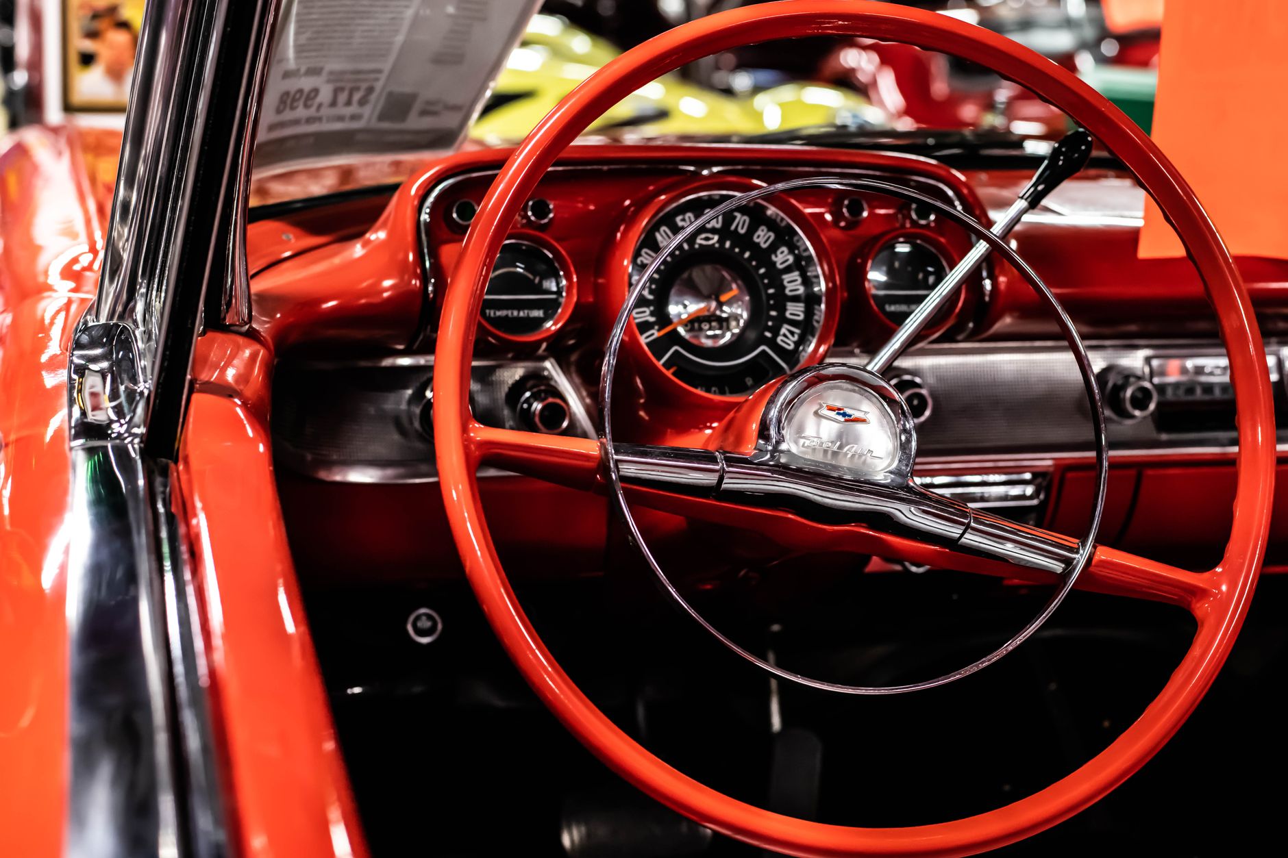 Detailed view of a vintage Chevrolet dashboard with red steering wheel.