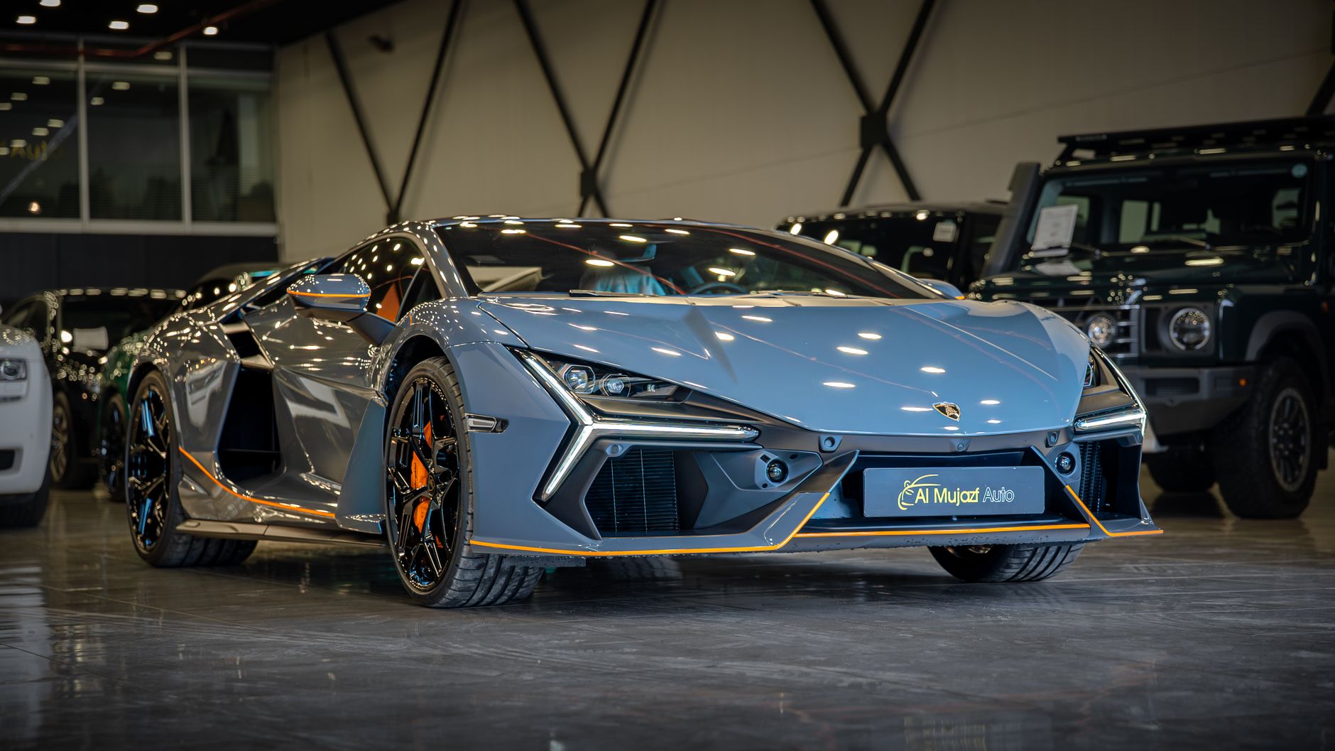 Elegant blue sports car displayed in a luxurious indoor car showroom setting.