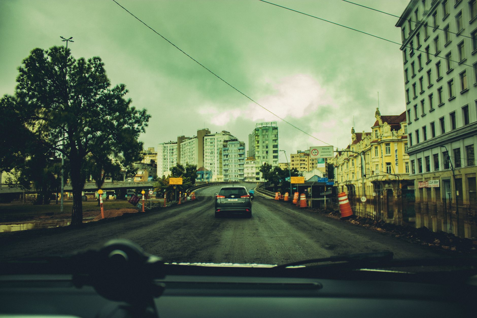 Street view of construction work amidst city buildings in Porto Alegre, Brazil.